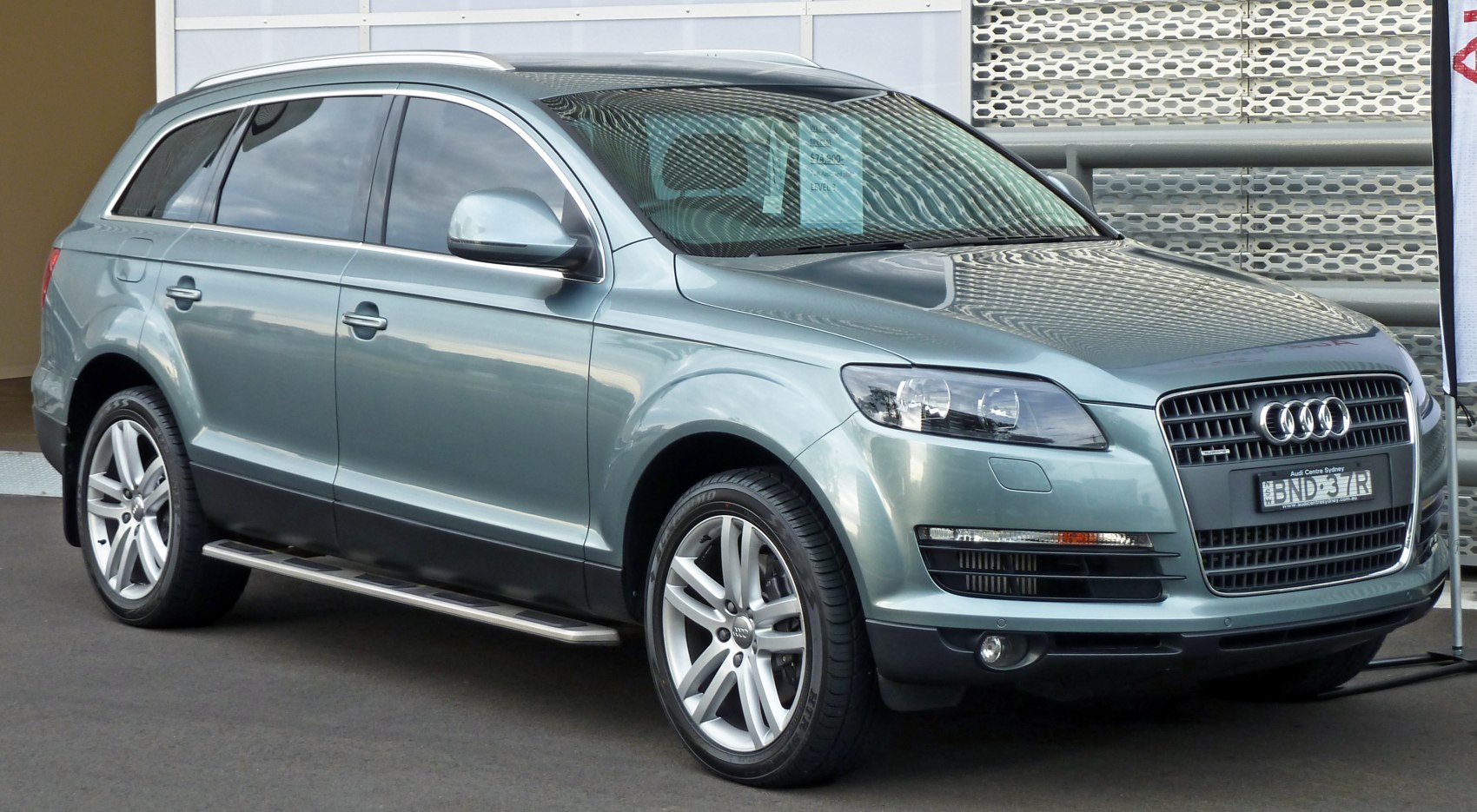 Front side view of a modern SUV with alloy wheels and sleek headlights