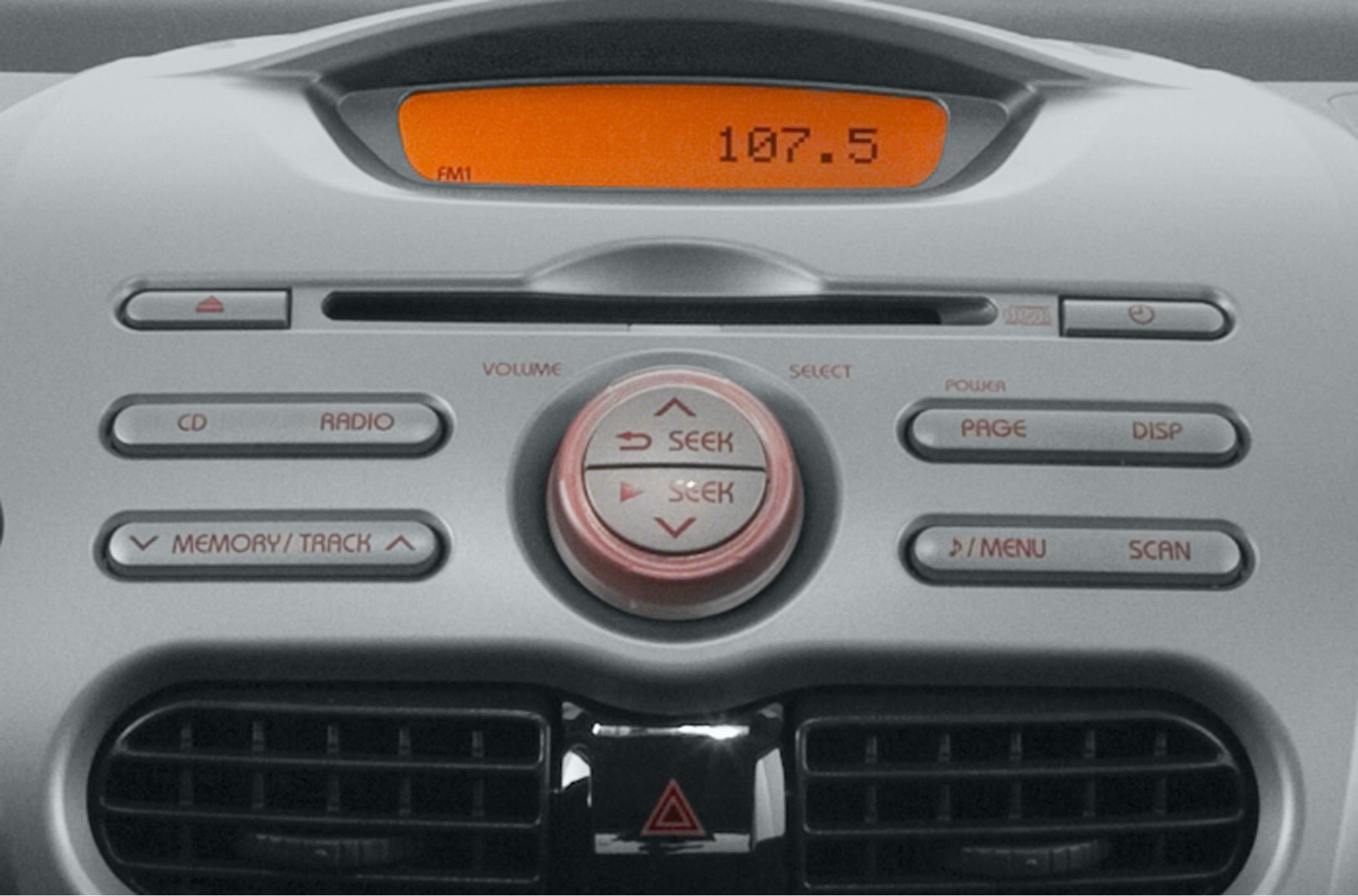 Close-up of car audio control panel with radio display and buttons