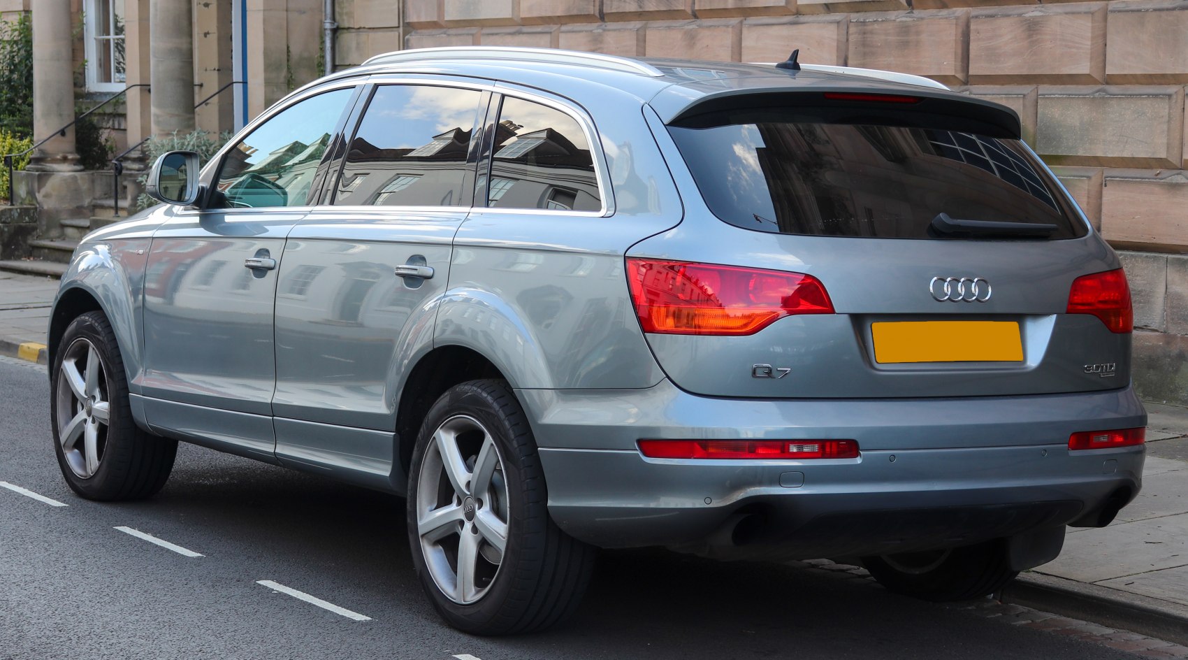 Rear side view of a silver SUV with distinct rear lights and alloy wheels