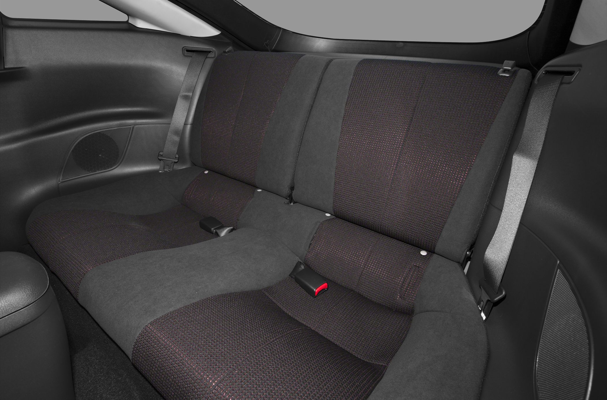 Rear upholstery and seating with seat belts and speaker grills