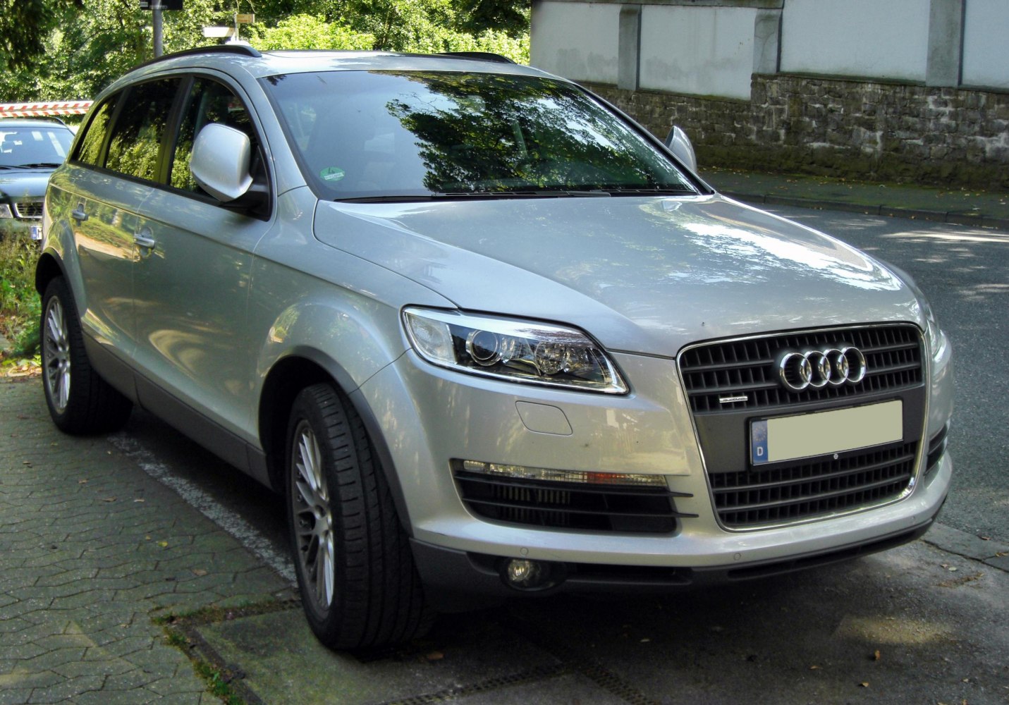 Front three-quarter view showing trapezoidal grille and LED headlight design.