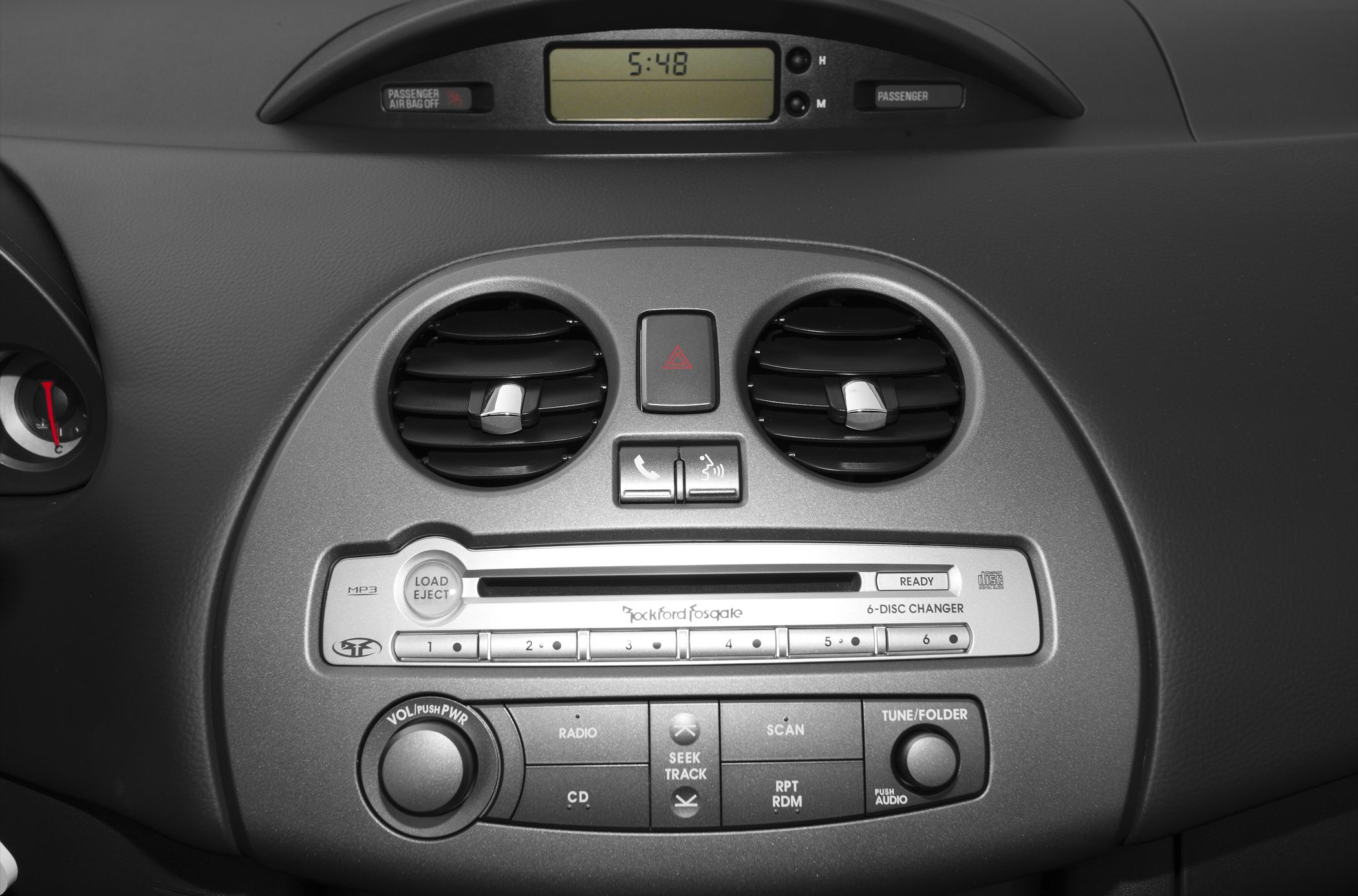 Dashboard air vents and 6-disc changer with control buttons.