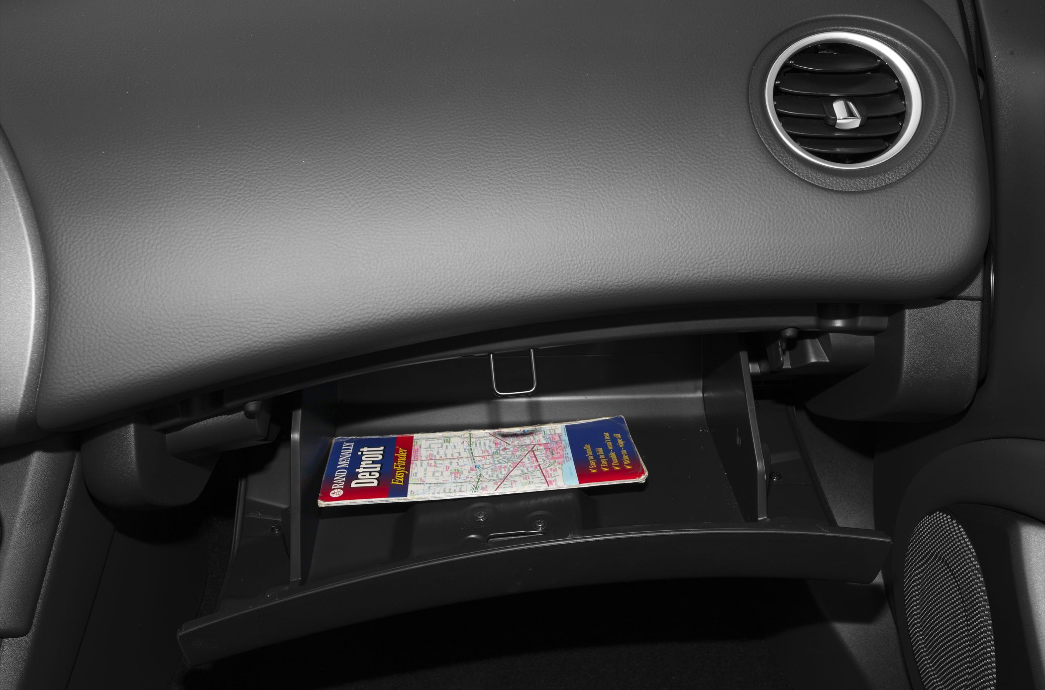 Close-up of glovebox and dashboard air vent interior details