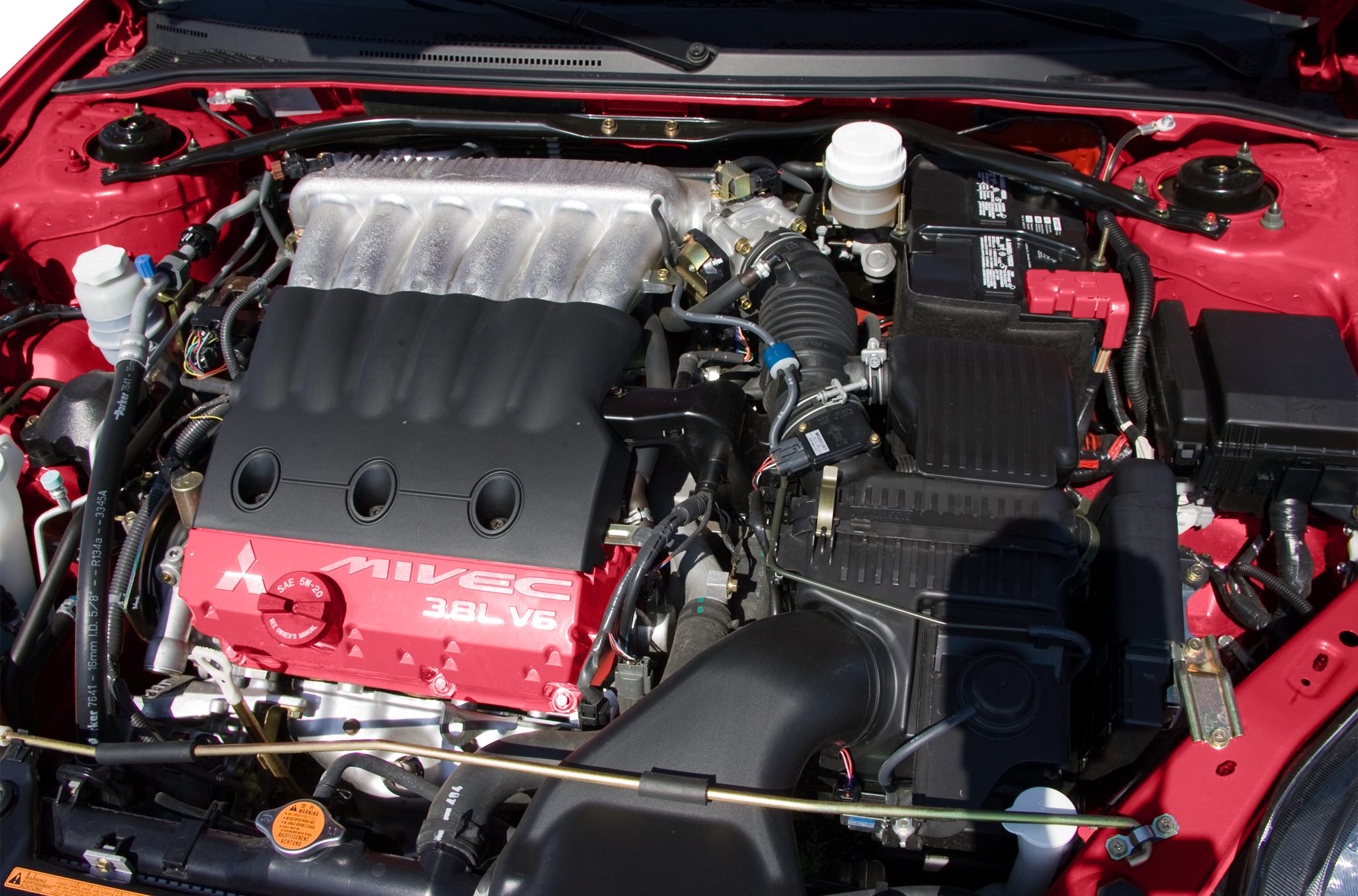 MIVEC 3.8L V6 engine bay with intake, battery and fluid reservoirs