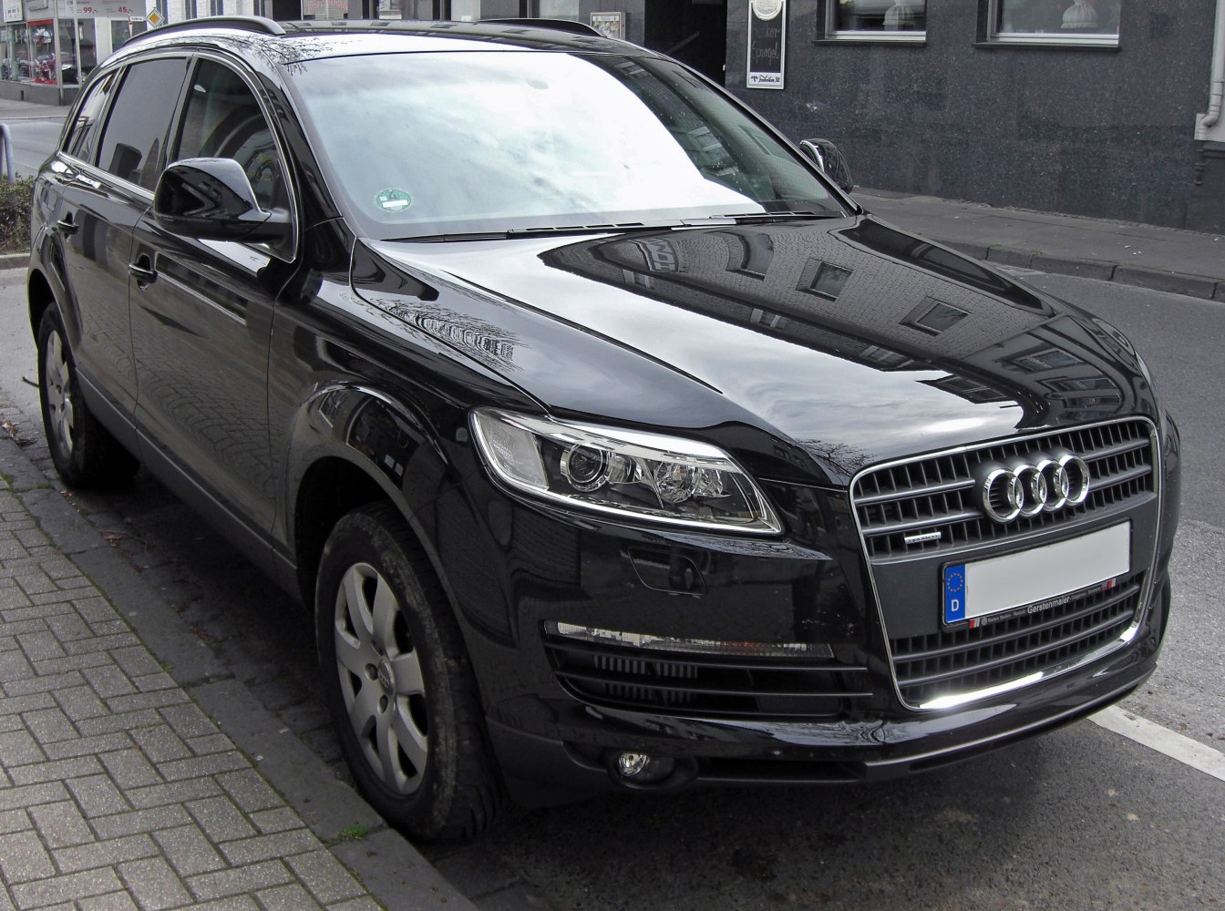 Front and side view of black Audi SUV with distinct grille and headlight design