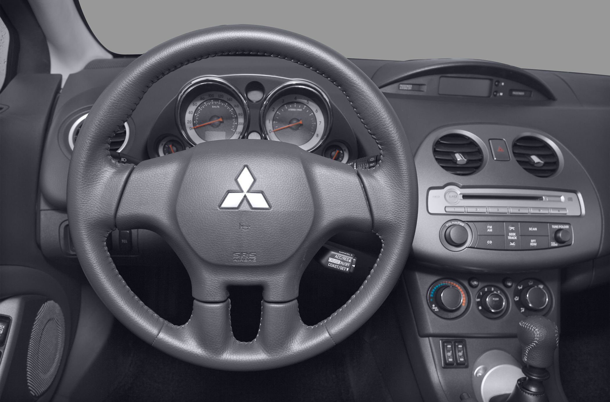 Steering wheel and dashboard with gauges and center console controls