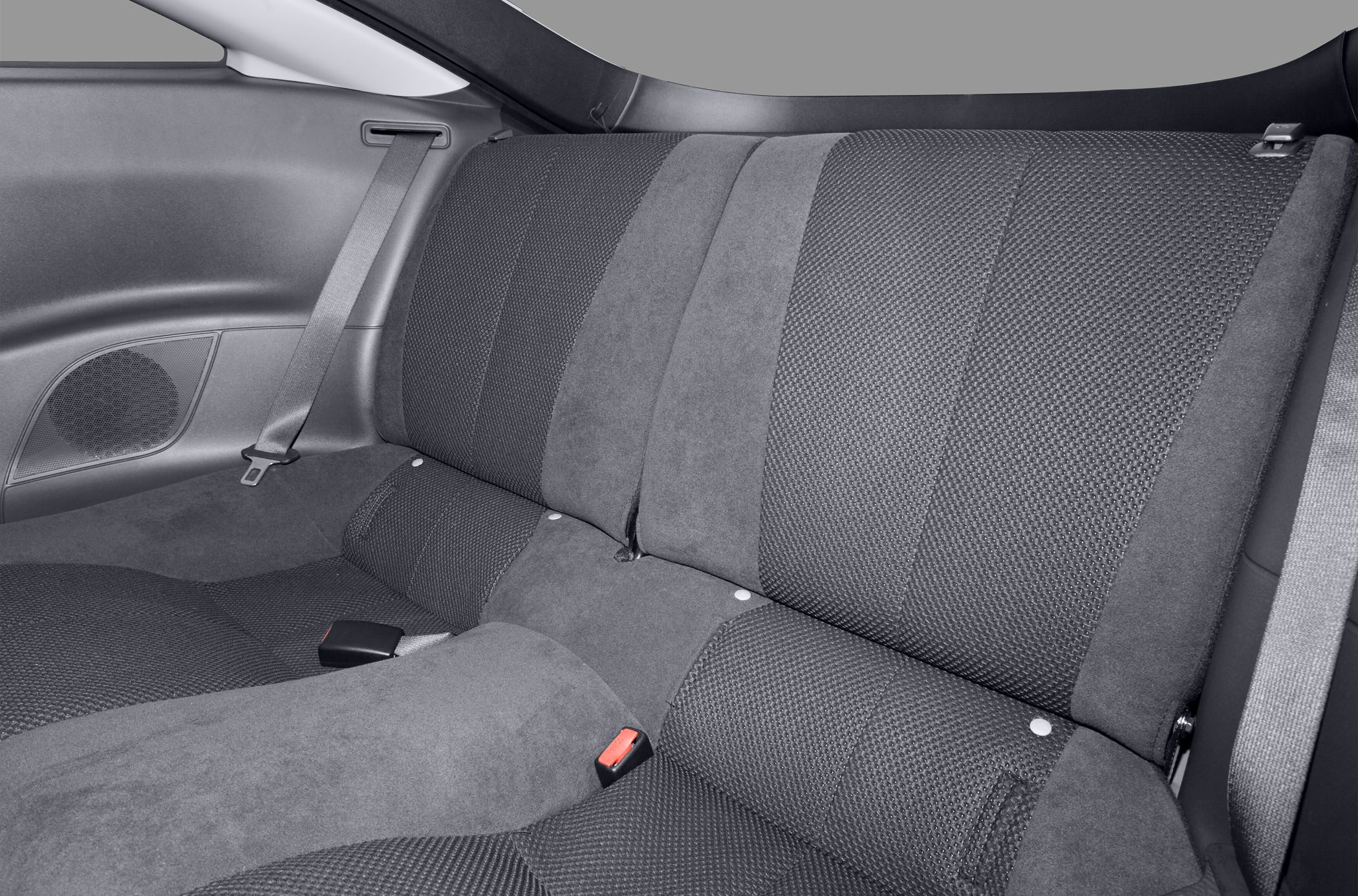 Two-tone textured and suede rear seats with seatbelts and speaker grille