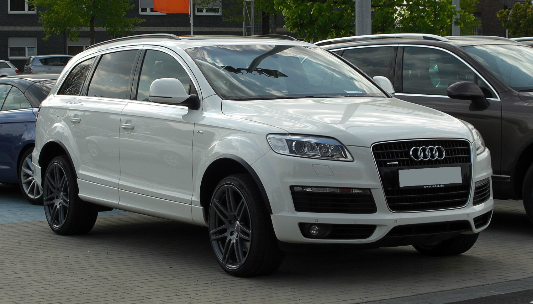 Front side view of luxury SUV with sleek design and large alloy wheels