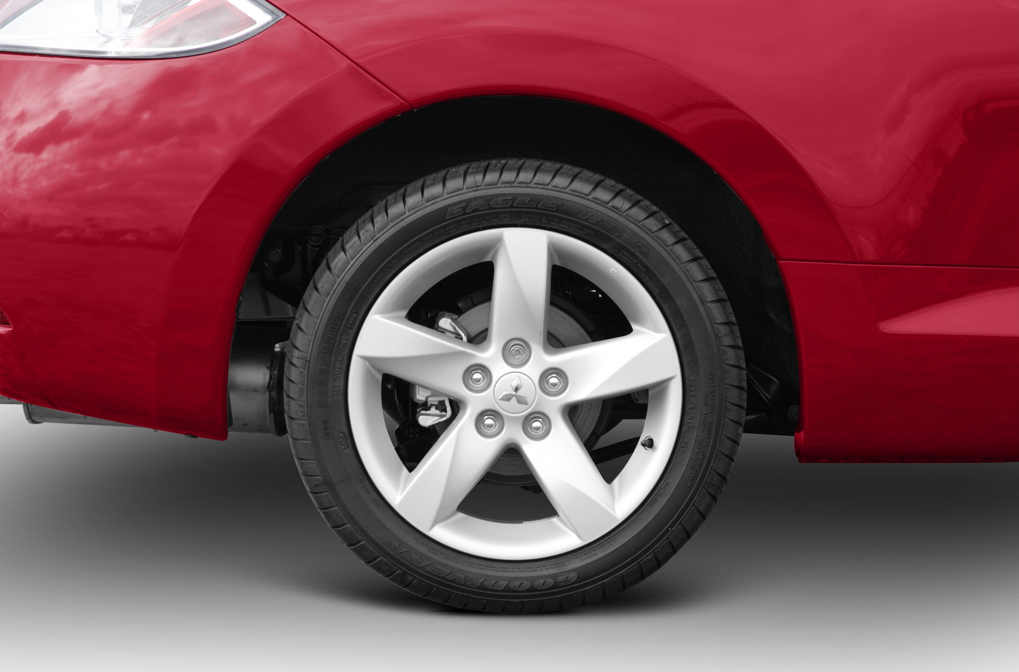 Close-up of alloy wheel and tire with brake disc behind.