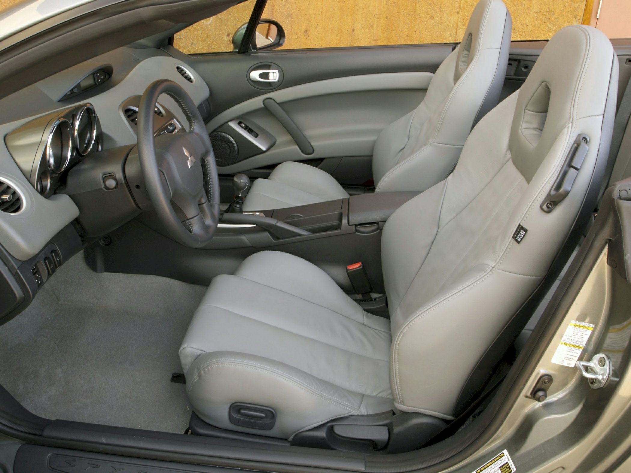 Leather seats and dashboard layout with manual gearshift.