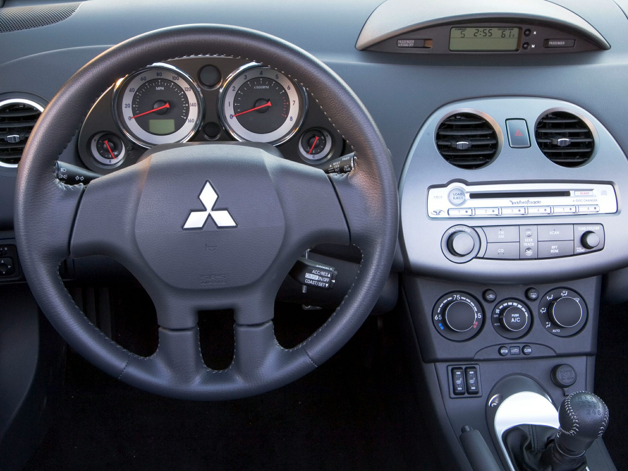 Dashboard, steering wheel, analog gauges, center console controls