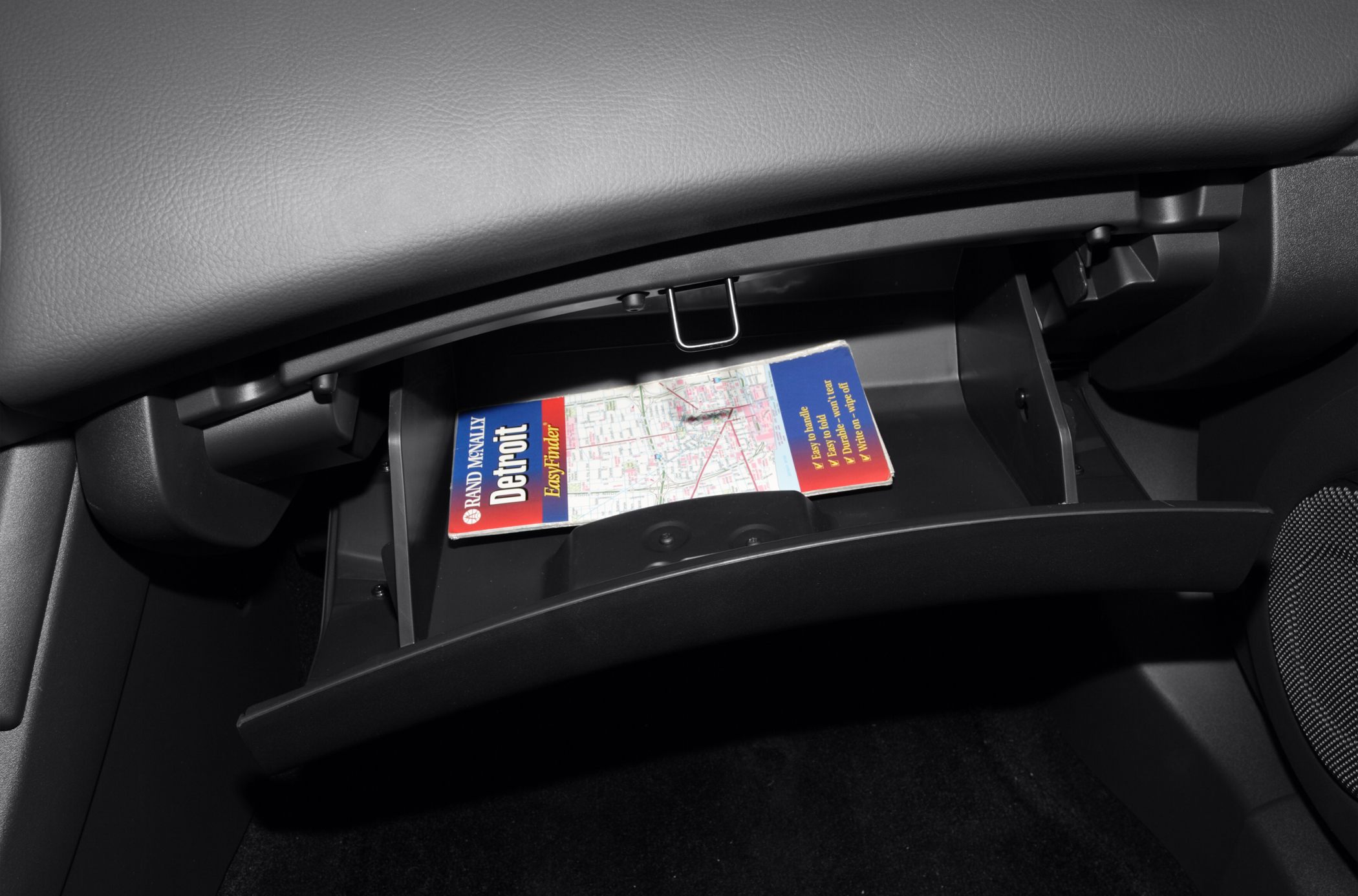 Open glove compartment with road map inside