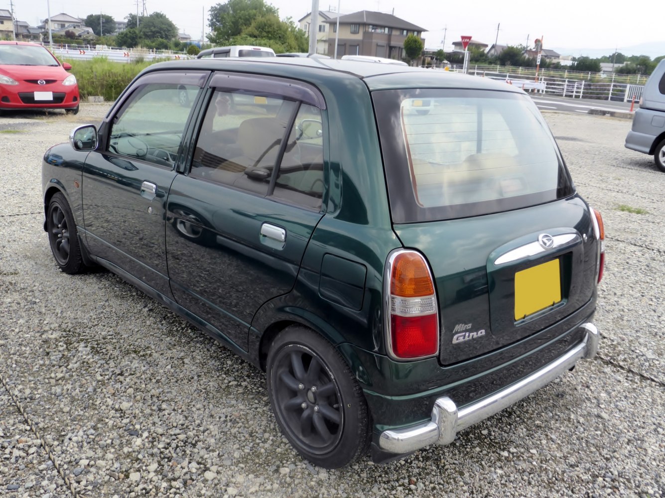 Compact retro hatchback with rounded taillights and chrome bumper