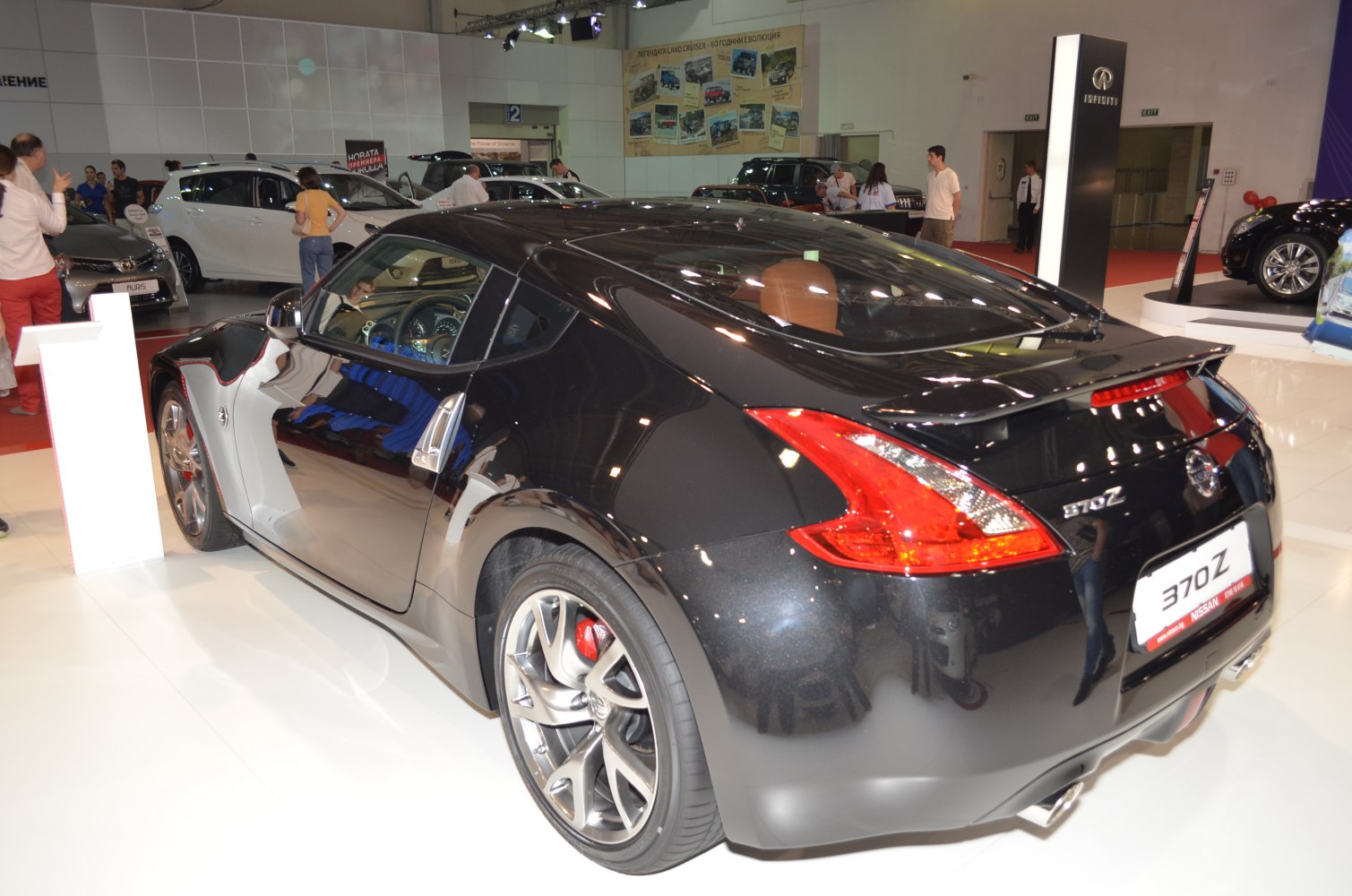 Rear side view of a black sports coupe with distinctive taillights and alloy wheels