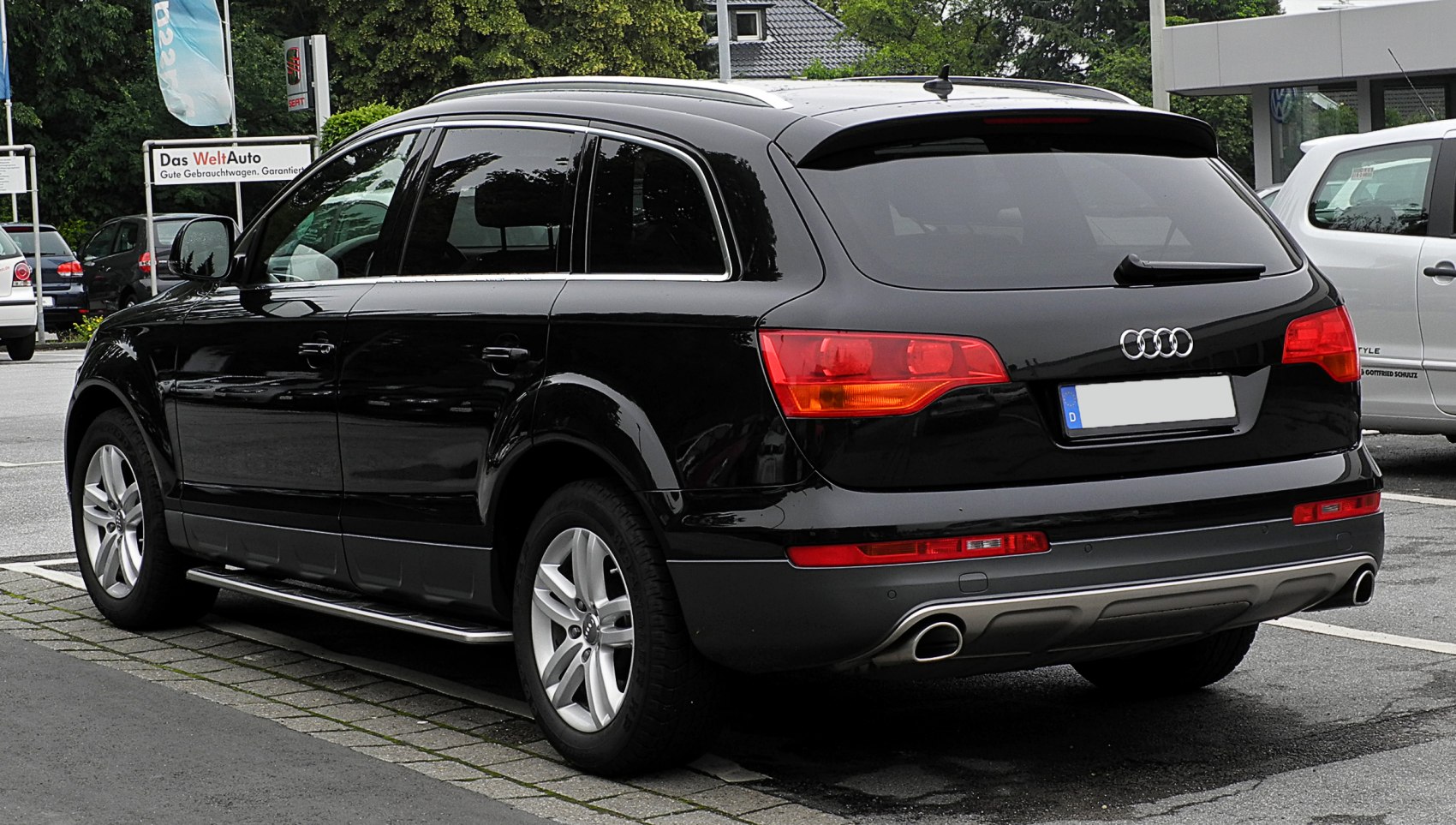 Rear and side view of luxury SUV with distinct taillights and dual exhausts
