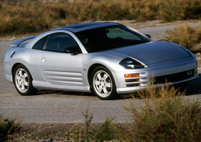 Silver coupe with pop-up headlights and alloy wheels in outdoor setting