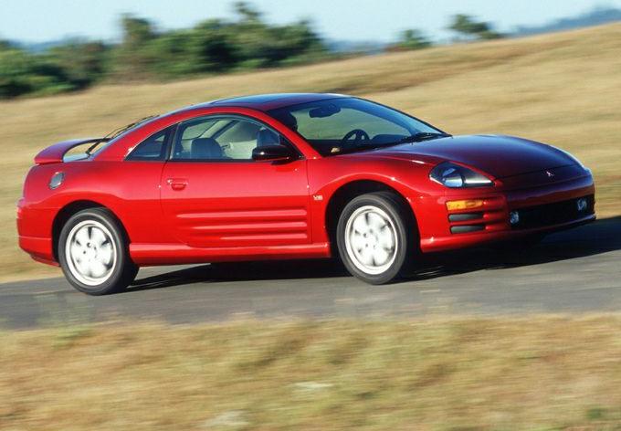 Red coupe side profile with rear spoiler and aerodynamic design