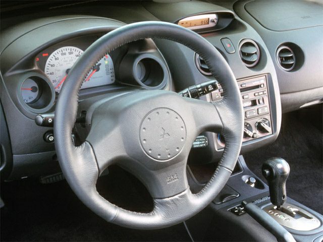 Steering wheel and dashboard with instrument cluster and center console controls