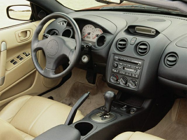Interior dashboard with steering wheel and center console including automatic gear shift