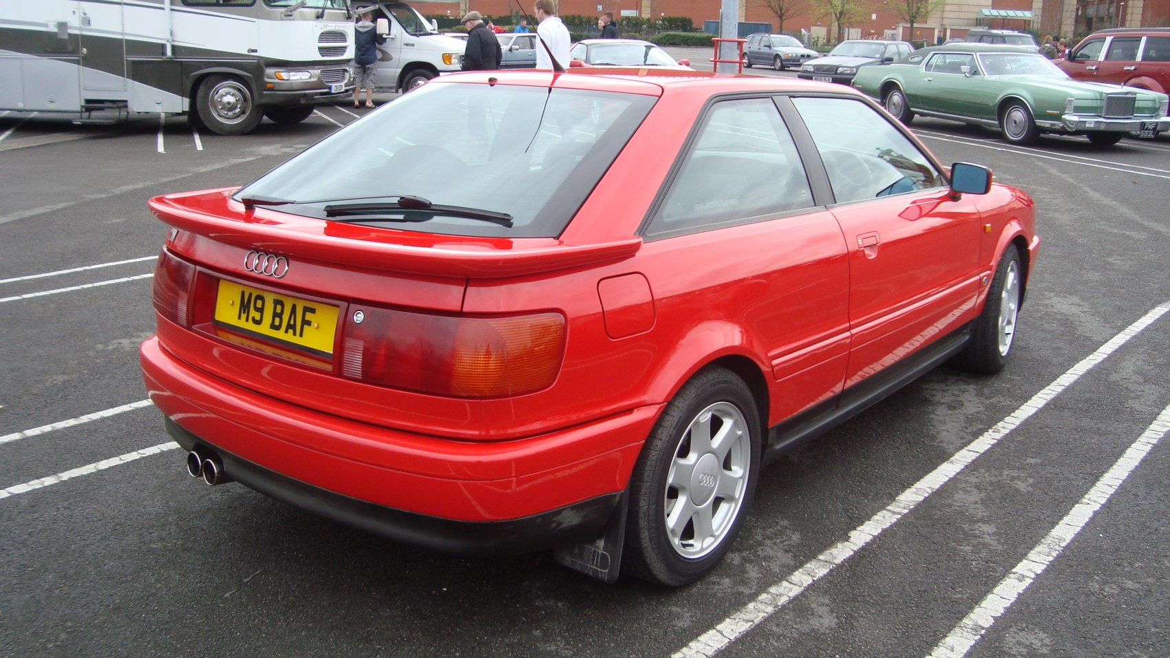Rear view of red coupe with spoiler and dual exhaust