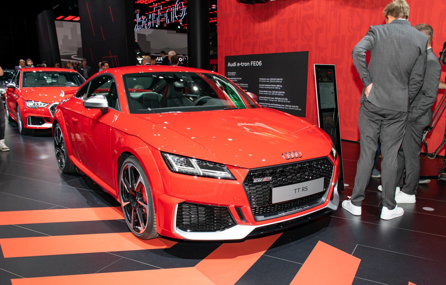 Red sports coupe with honeycomb grille and alloy wheels