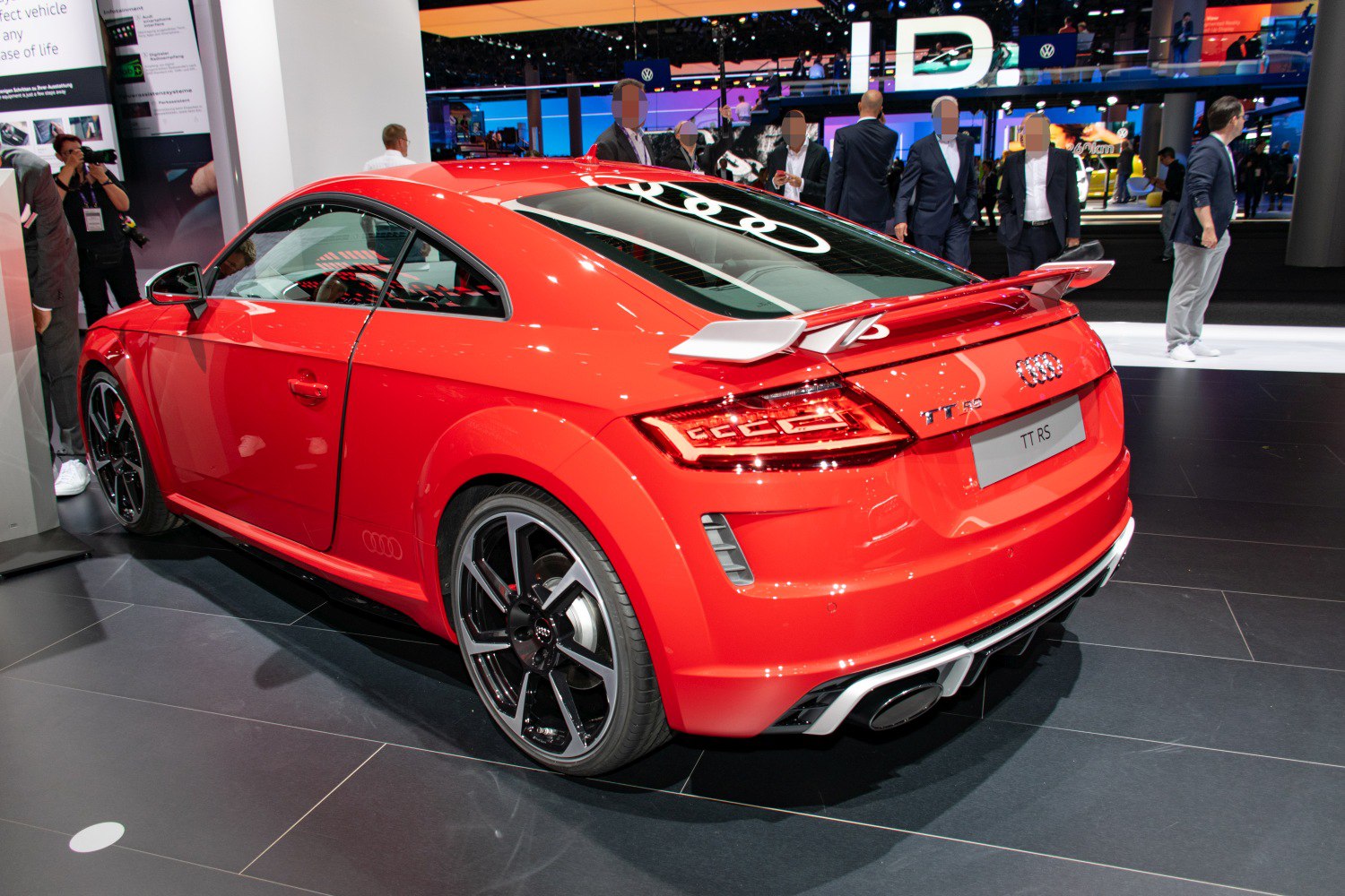 Rear and side view of a sports coupe with spoiler and sporty wheels