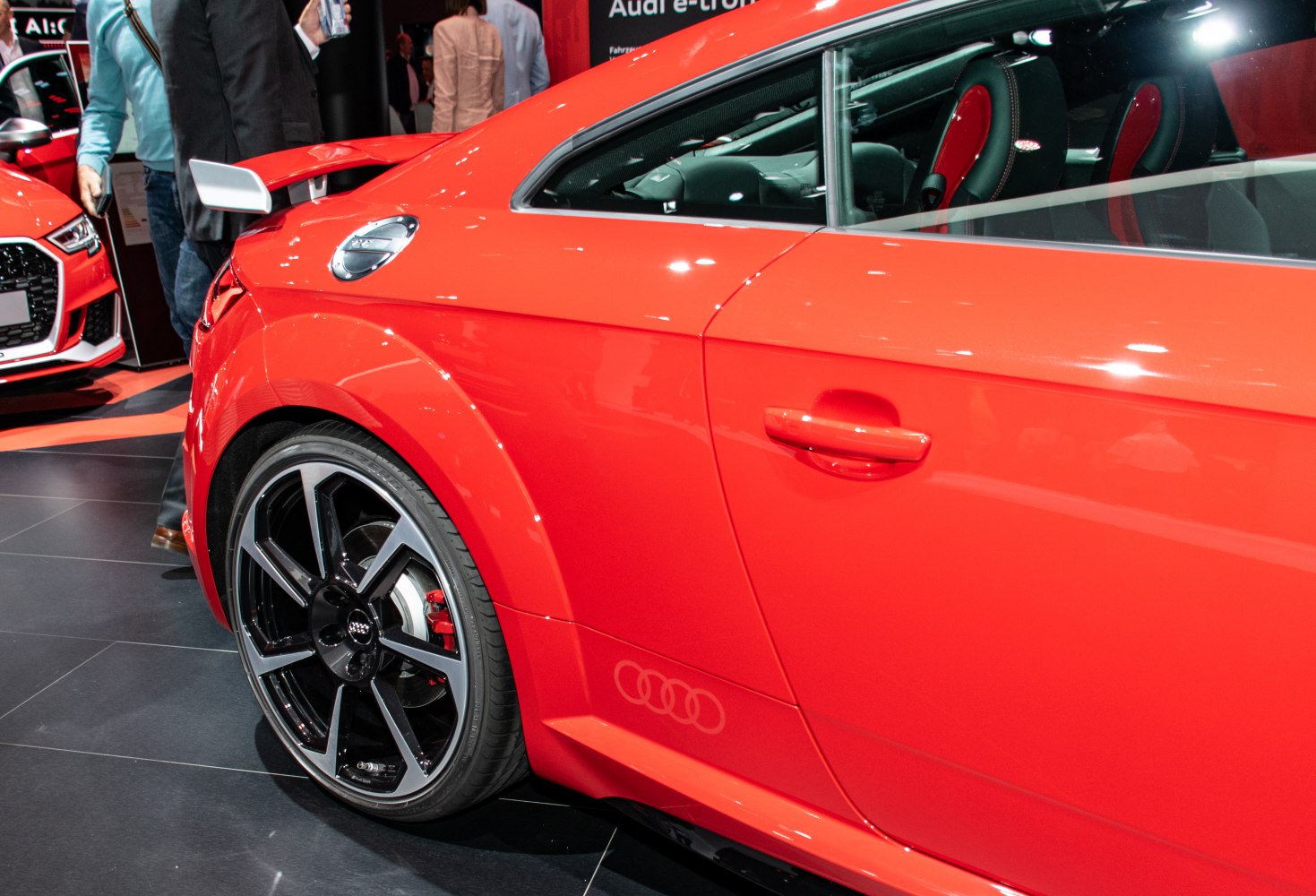 Close-up of rear side, wheel, and sporty features on a coupe.