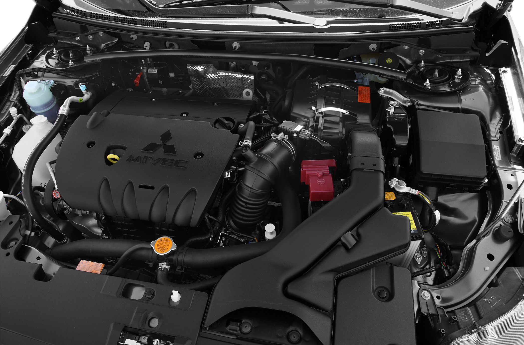 MIVEC engine with visible air intake, battery, and coolant reservoir under hood.