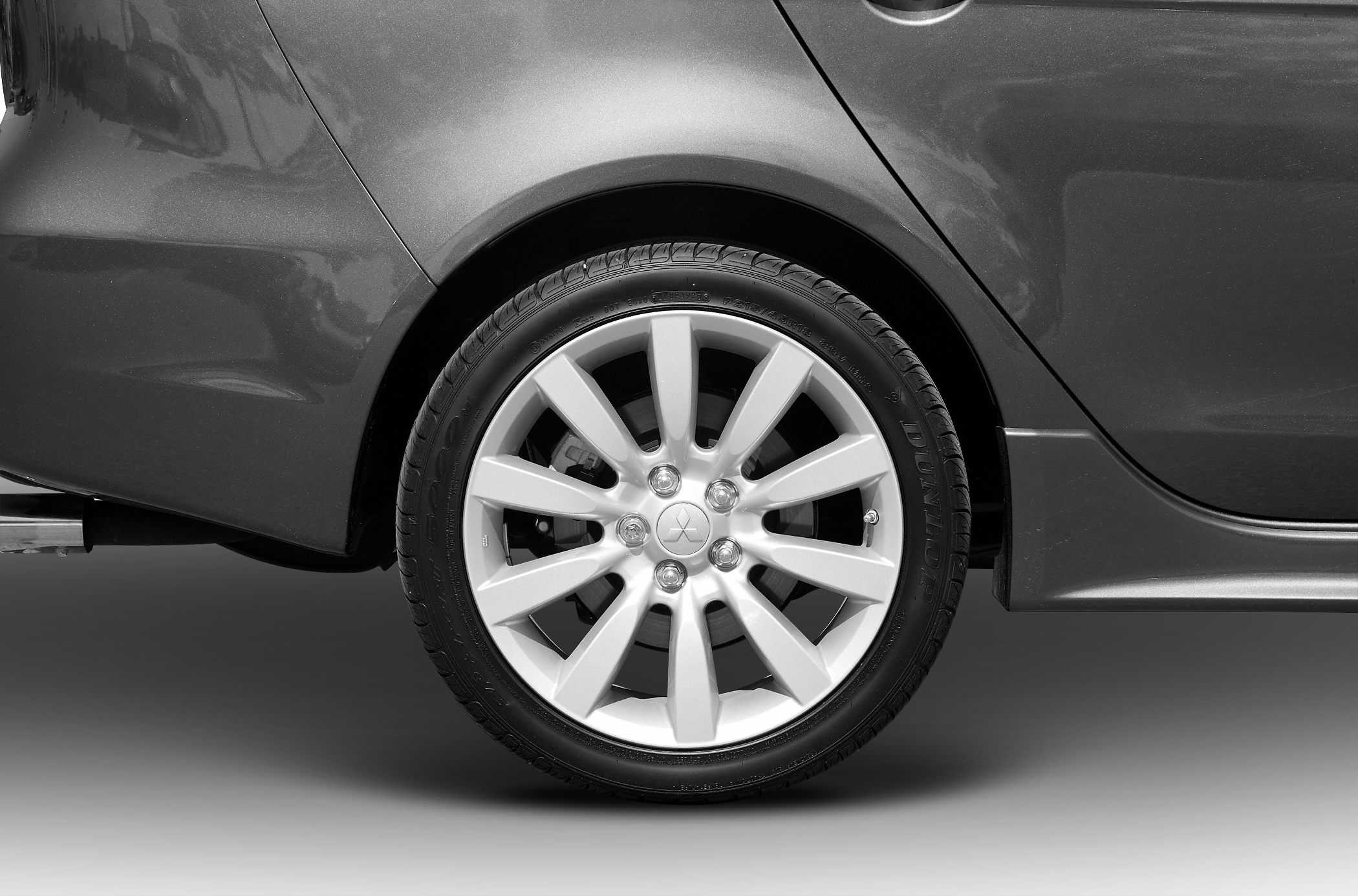Close-up of alloy wheel with Dunlop tire on rear side of vehicle