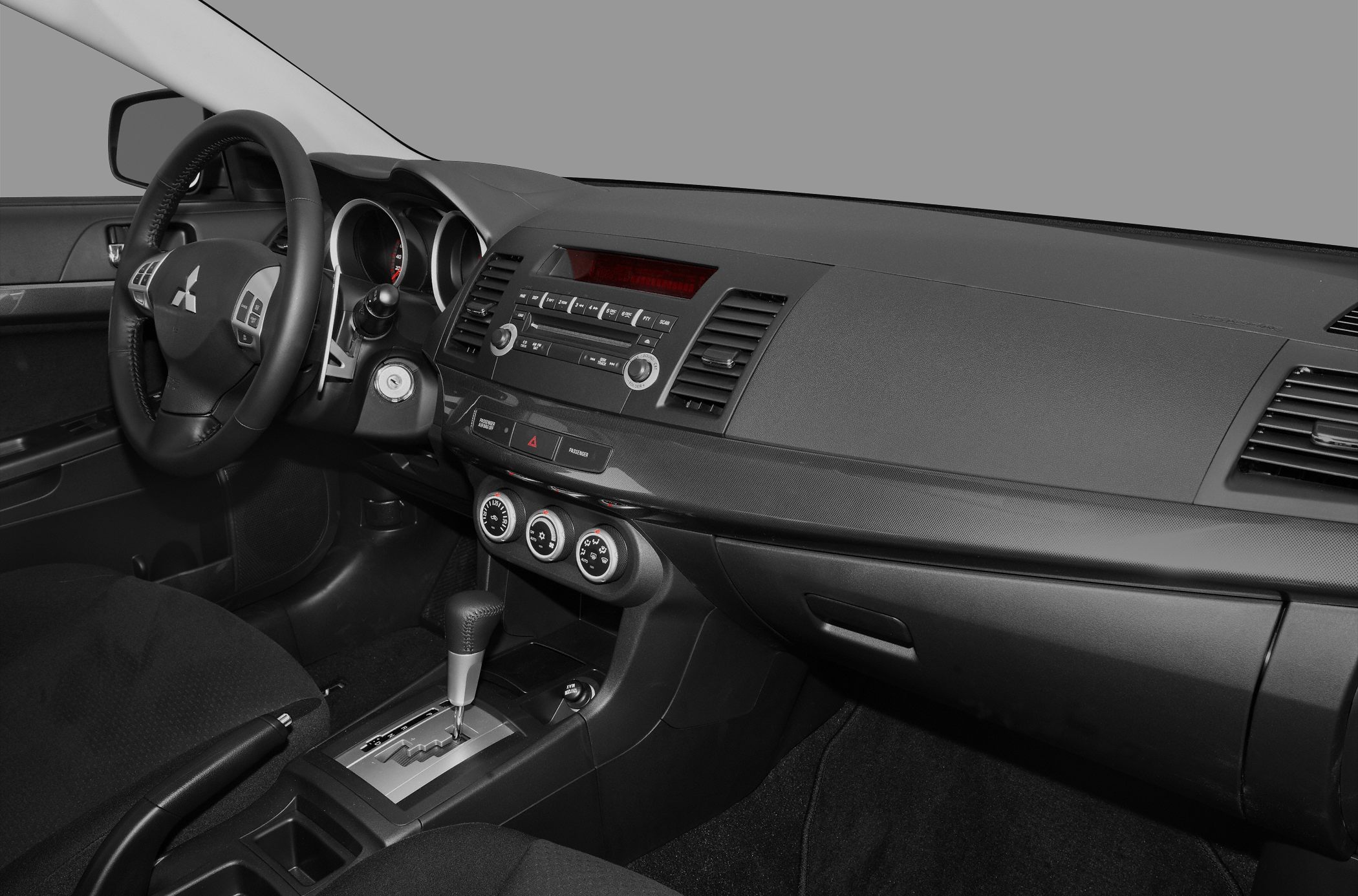 Dashboard with center console, steering wheel, and gear shifter in a car interior
