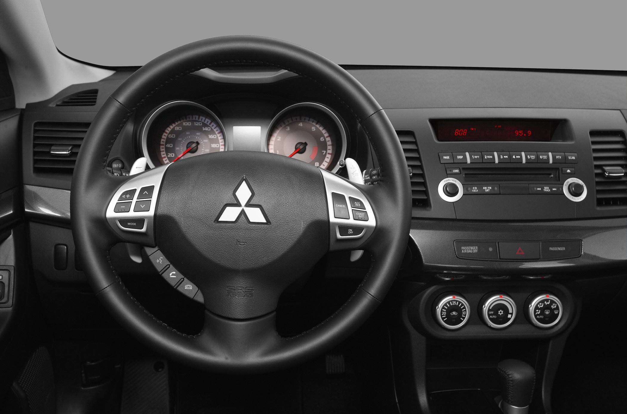 Steering wheel with controls and instrument cluster of a 2008 model.