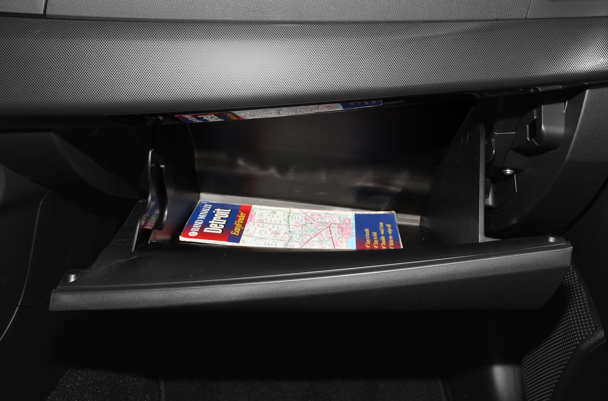 Open glove compartment with a map inside