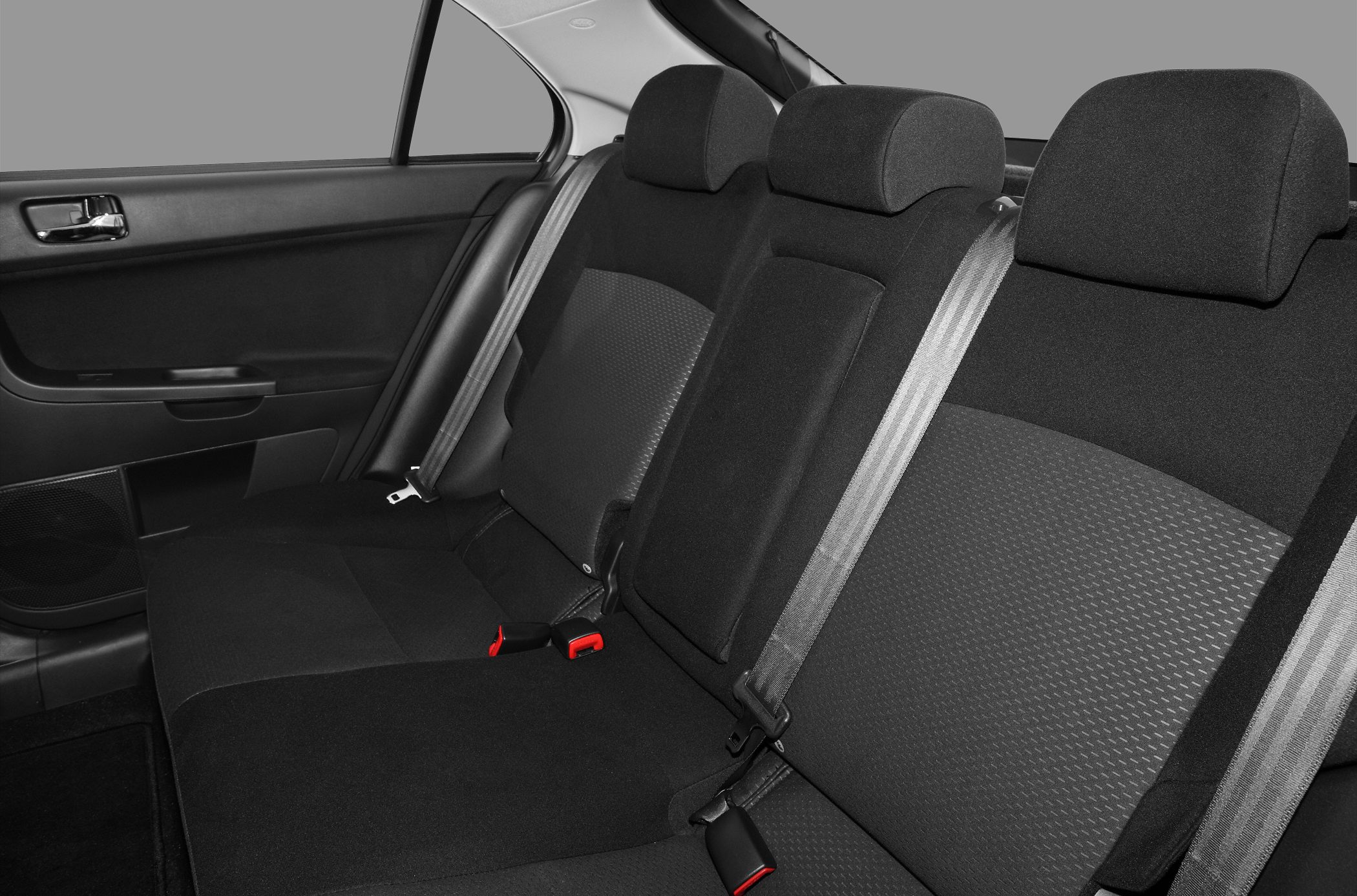 Rear seat interior with fabric upholstery and seatbelt details