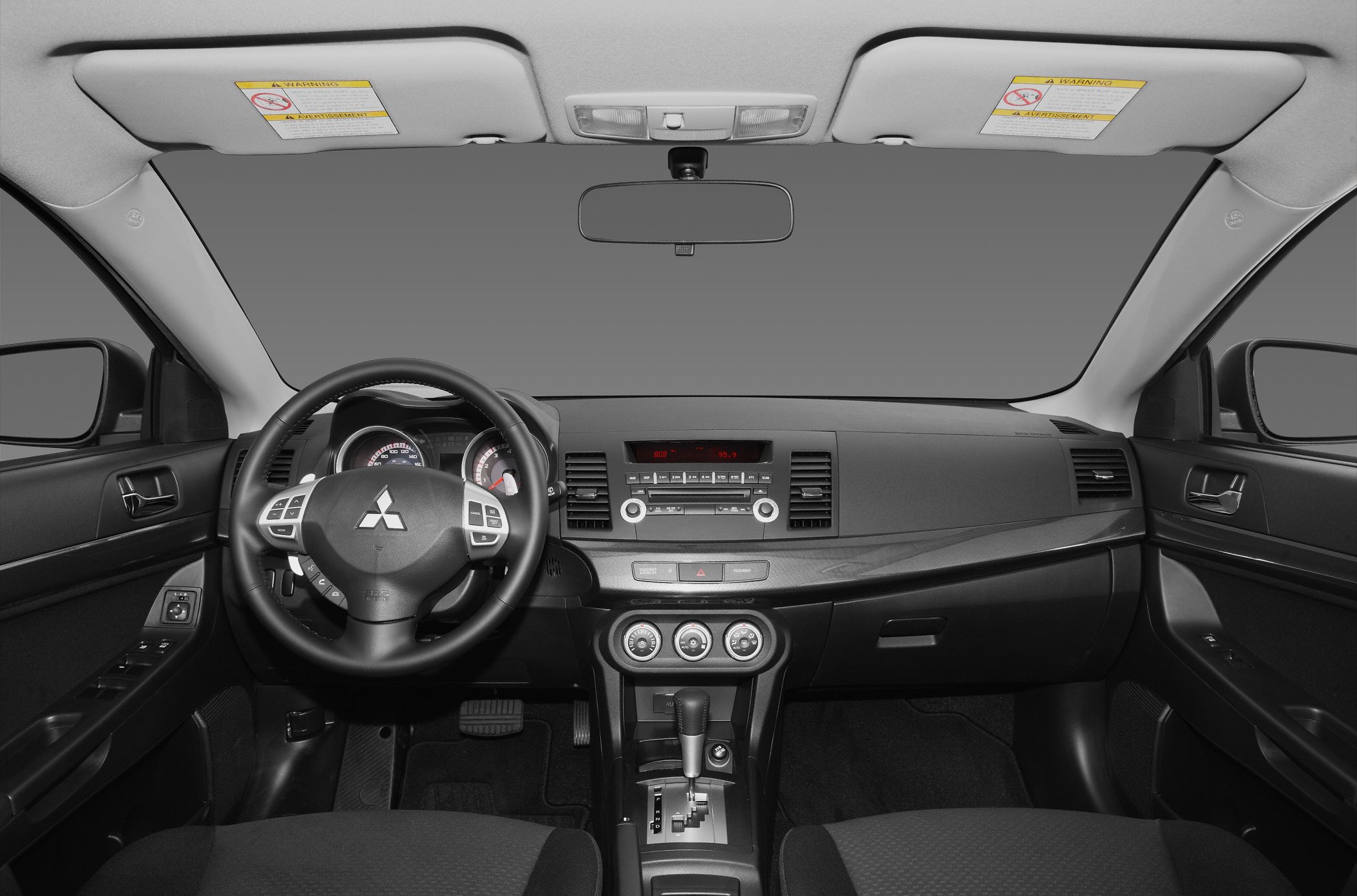 Car interior dashboard and steering wheel with control buttons and gear shifter
