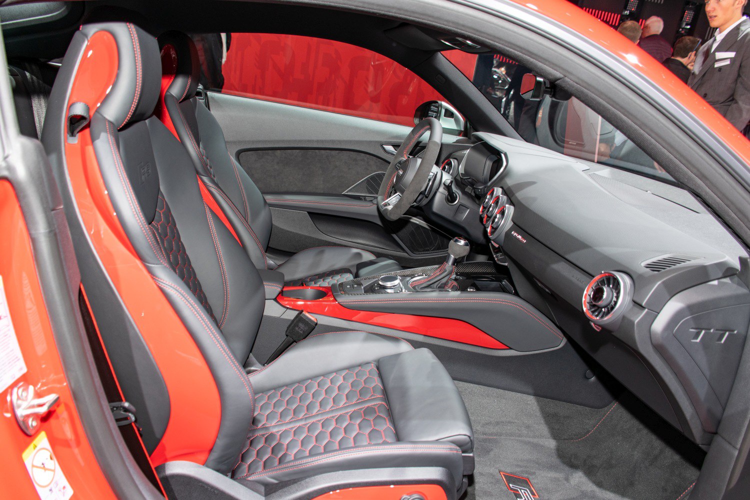 Sporty leather seats with red stitching and modern cockpit design.
