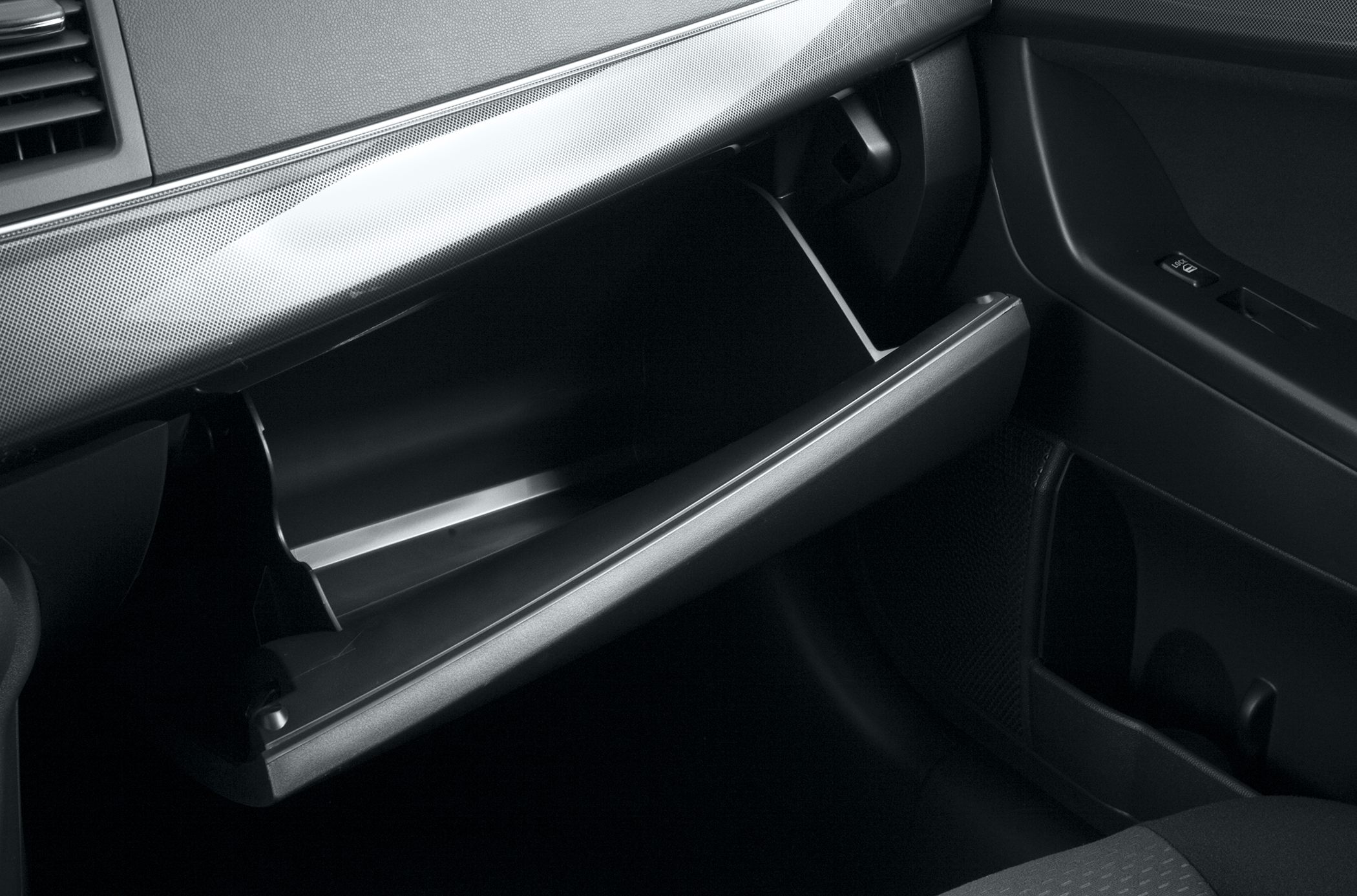 Open glove compartment inside a modern sedan interior