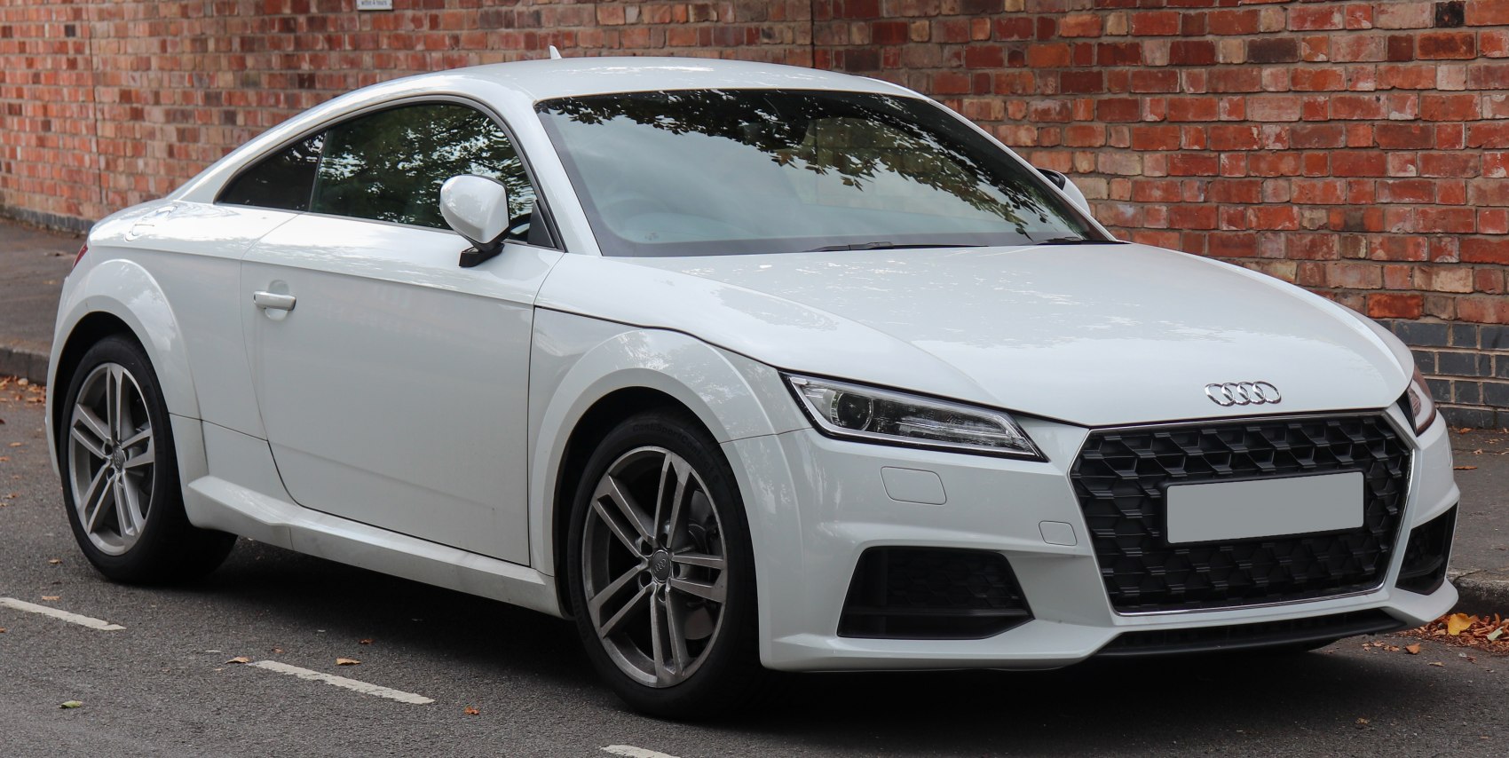 White coupe with hexagonal grille and LED headlights