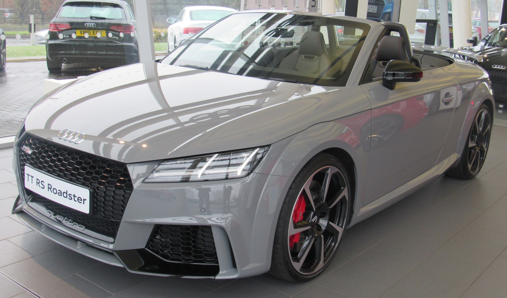 Front view of a convertible with LED headlights and sporty black grille