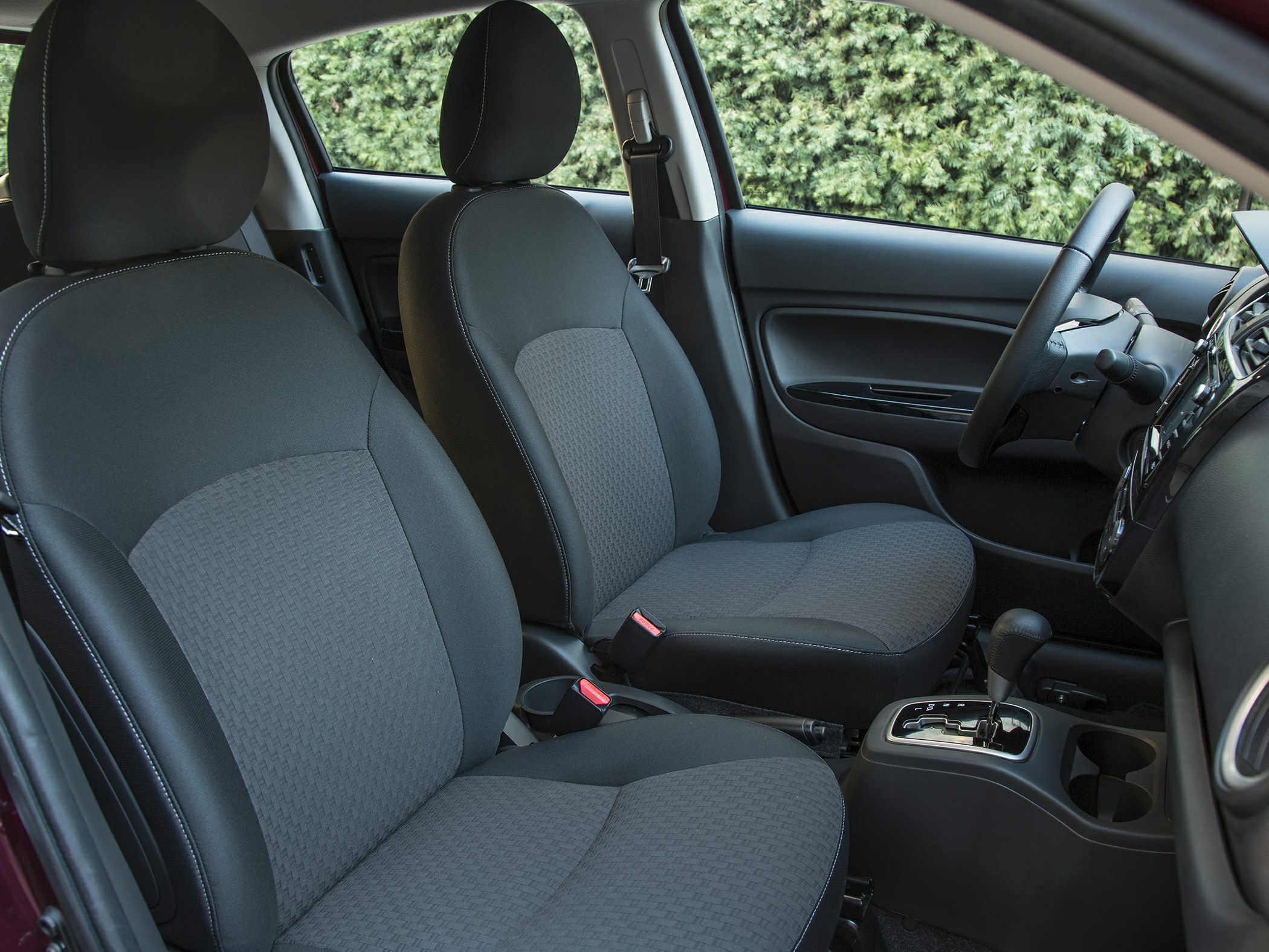 Front interior seating and dashboard layout with automatic gear shift.