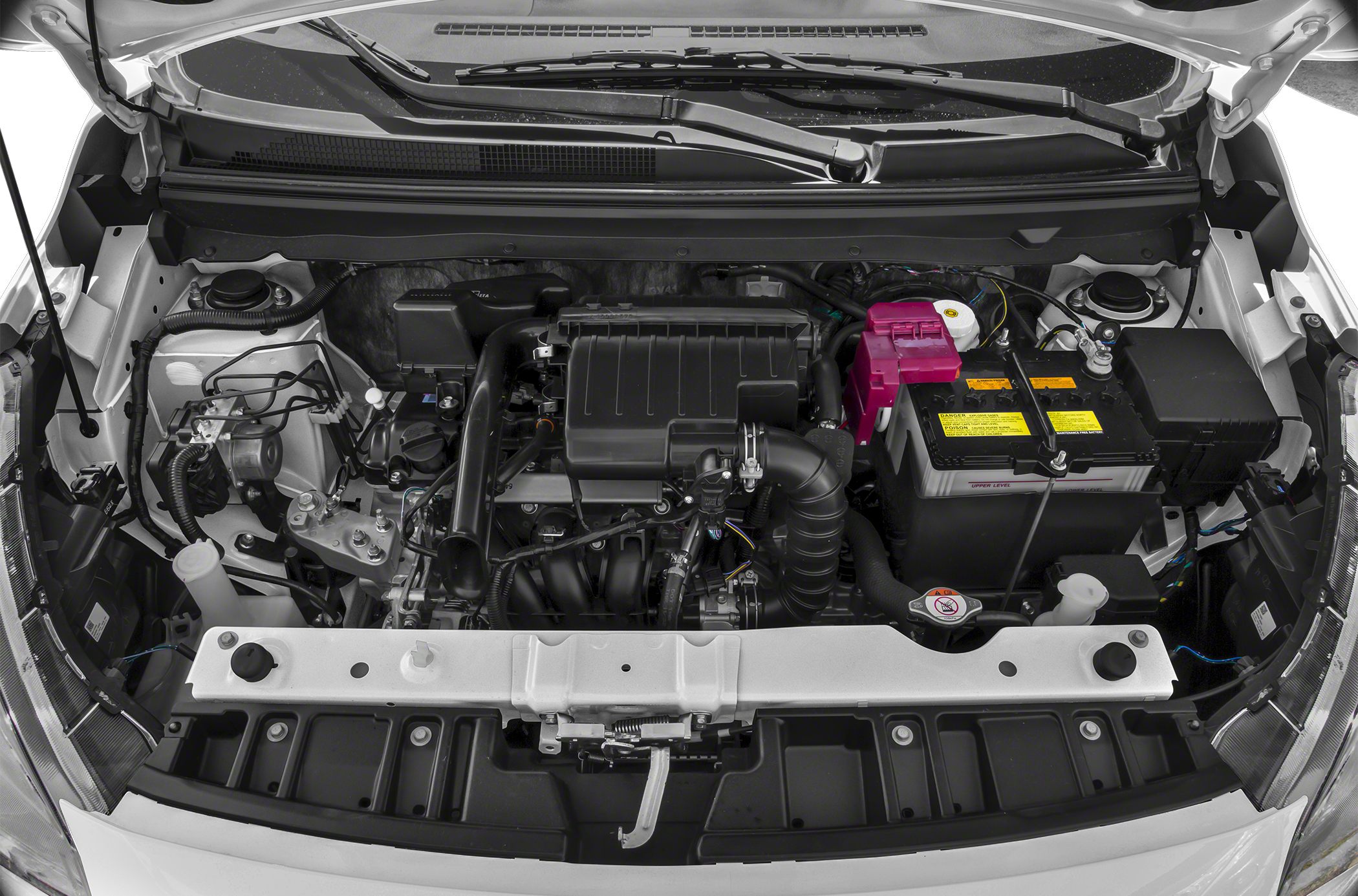Engine bay with air filter, battery, hoses, and wiring