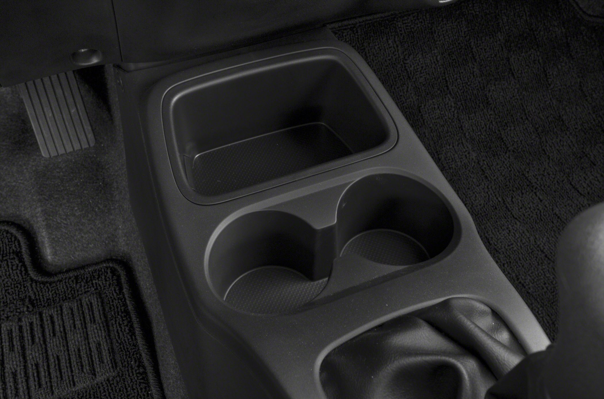 Black center console with dual cup holders and storage compartment