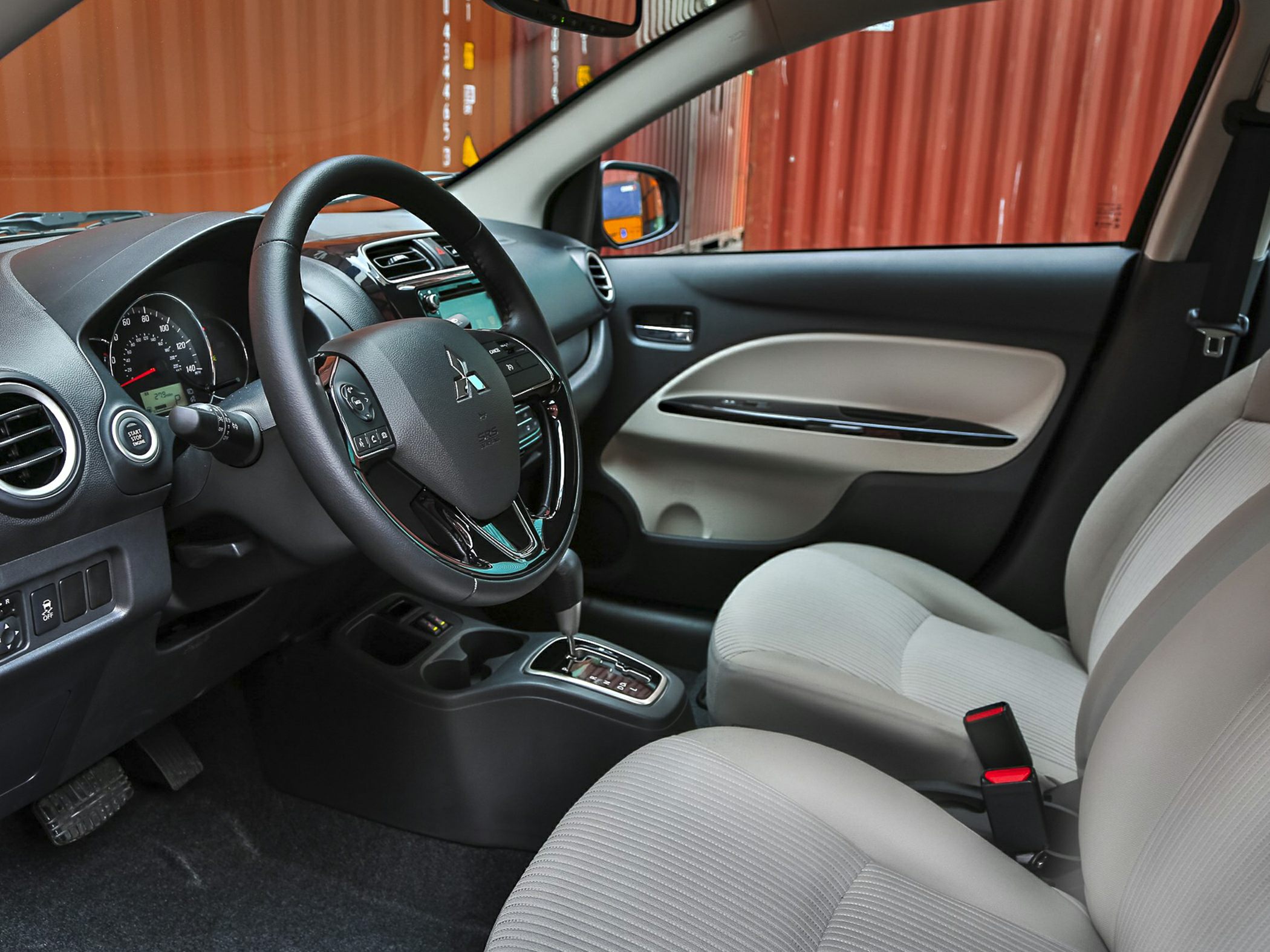 Interior view highlighting steering wheel, dashboard, and front seats.