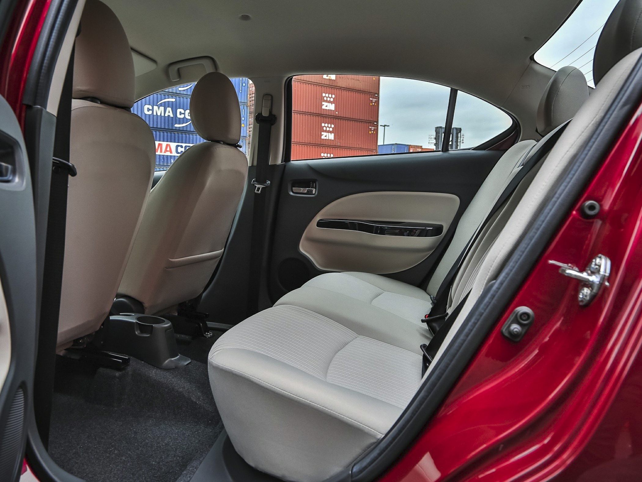 Rear interior seating and door panel with light upholstery and seat belts