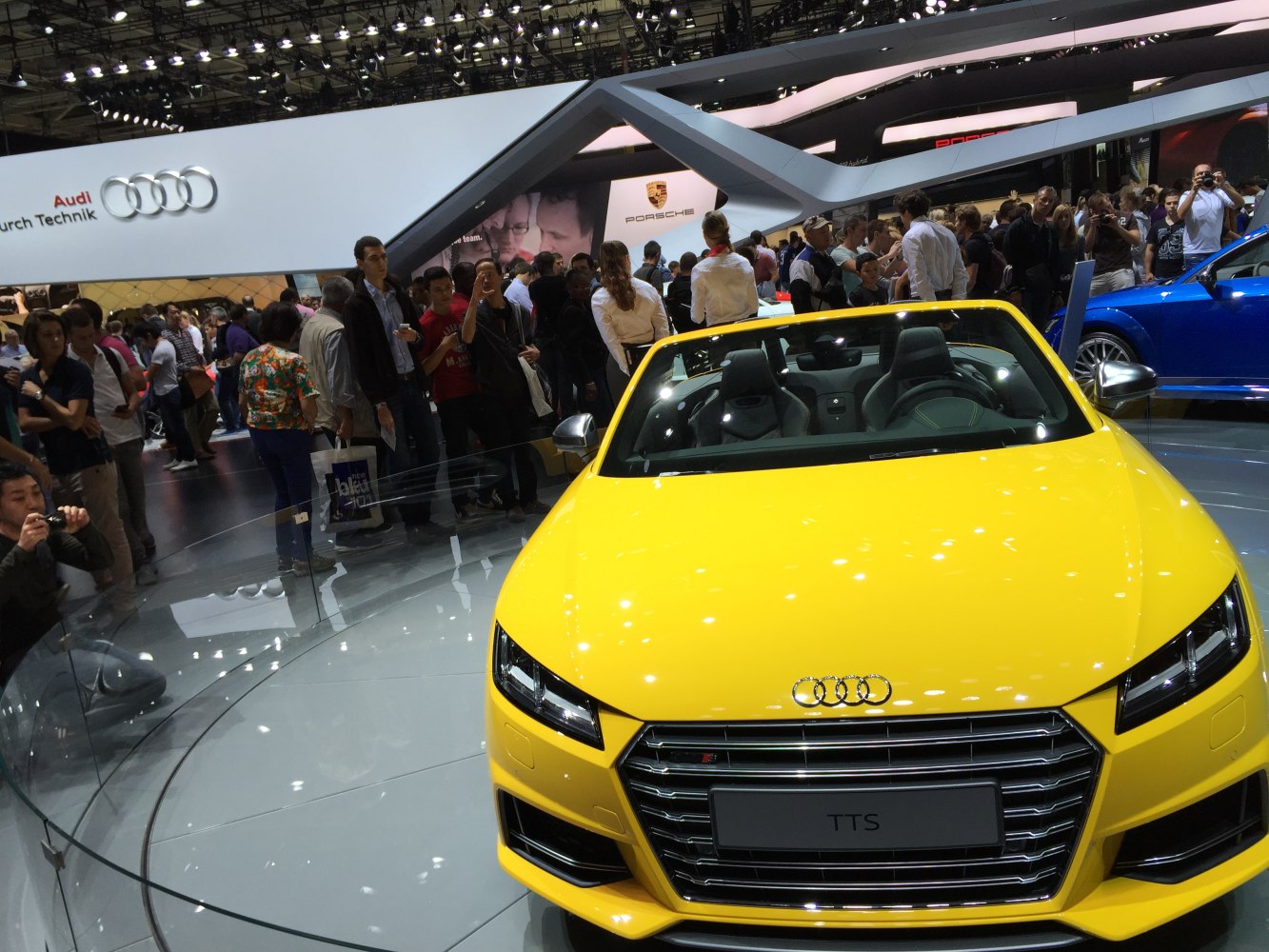 Front view of yellow convertible with distinctive grille and headlights