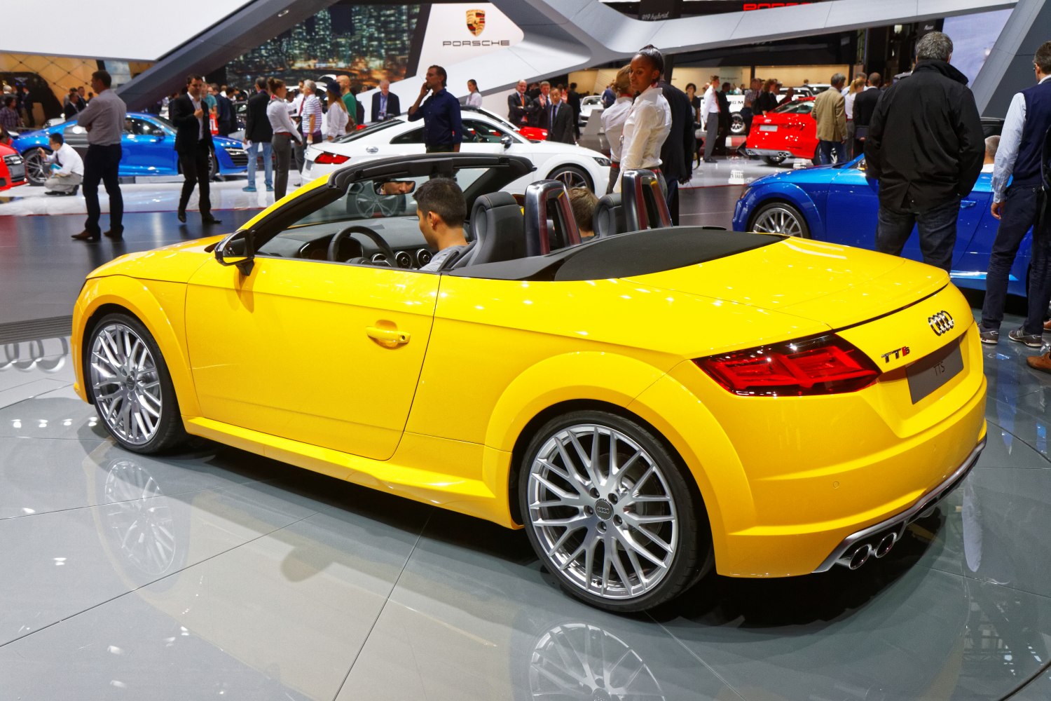 Bright yellow convertible with dual exhaust and large alloy wheels