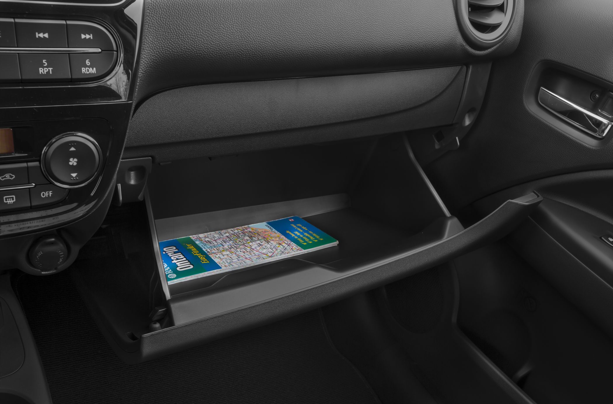 Open glove compartment with map inside, car interior detail