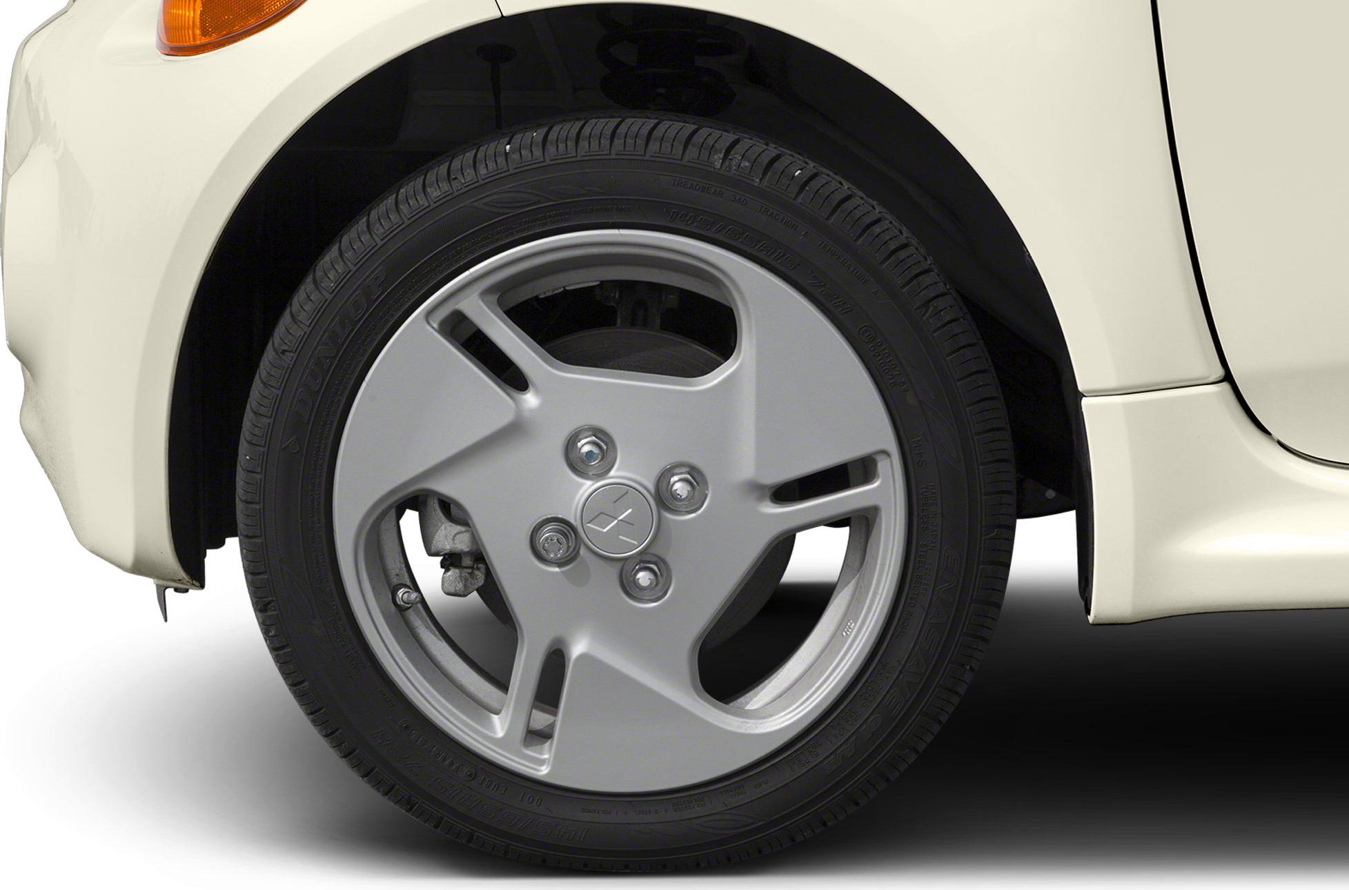 Close-up of 3-spoke alloy wheel and tire on vehicle