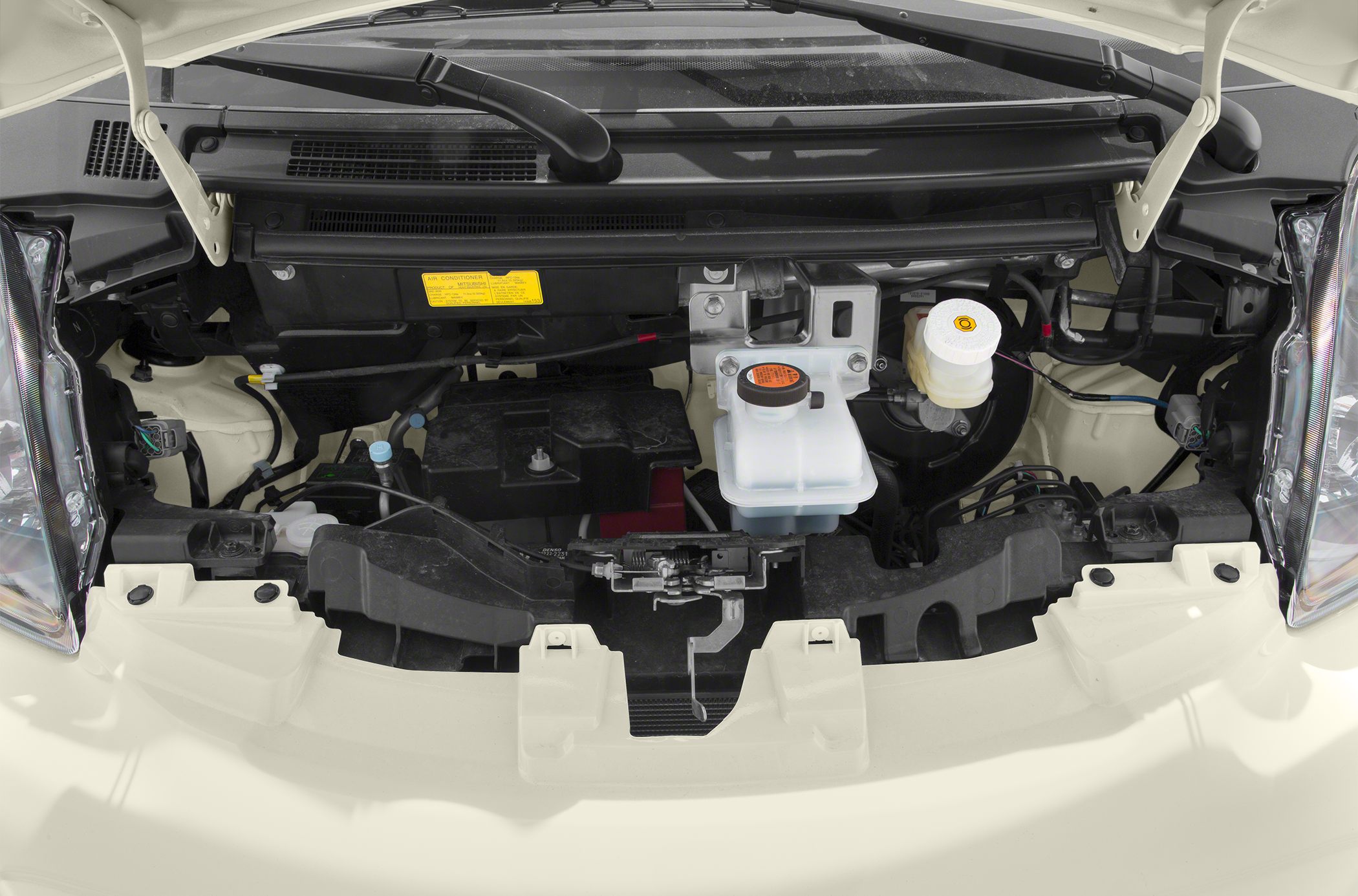 engine compartment with fluid reservoirs and electric motor components