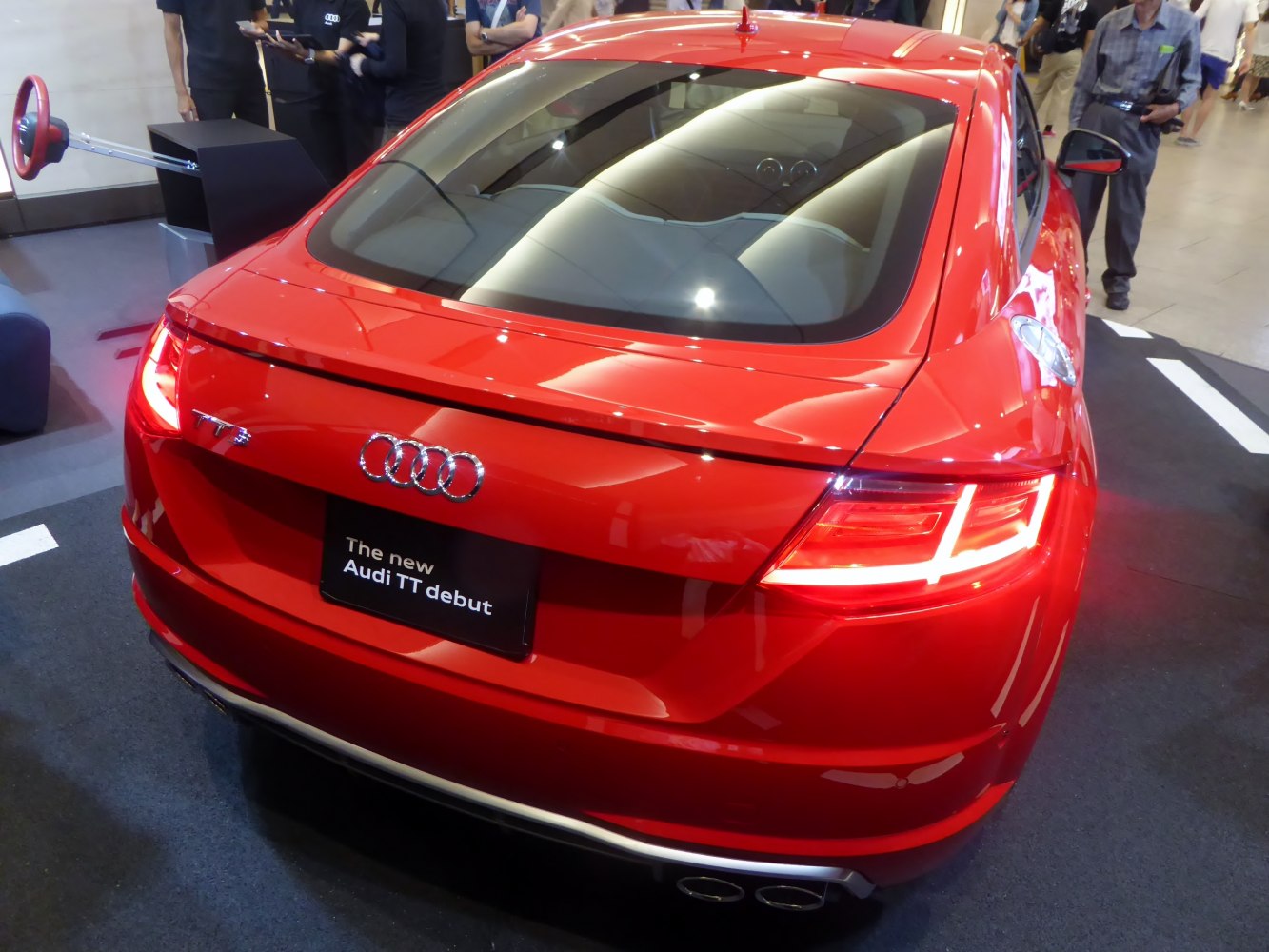 Rear view of a sporty coupe with LED tail lights and dual exhausts