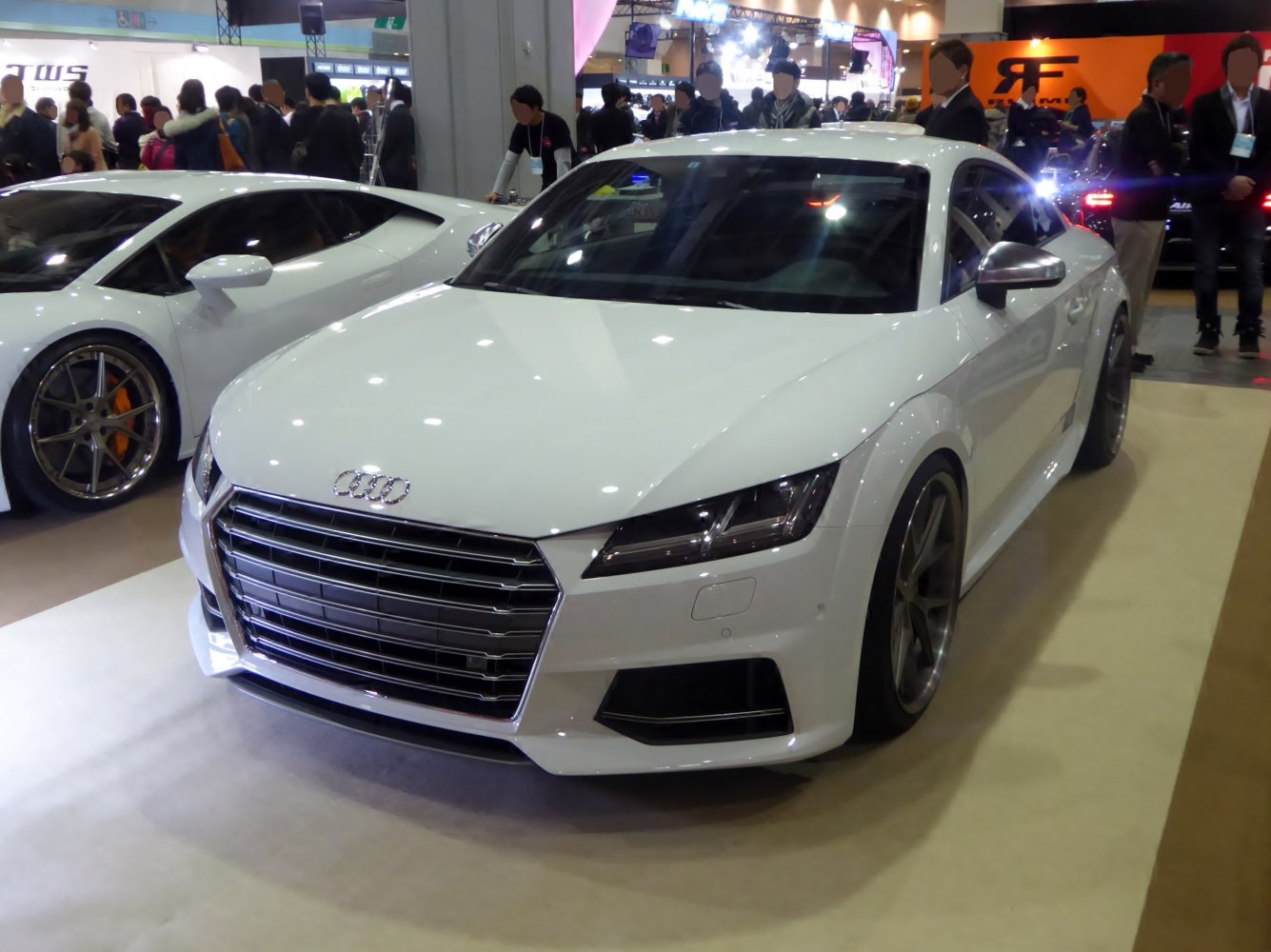 White sports coupe, large chrome grille, angular LED headlights